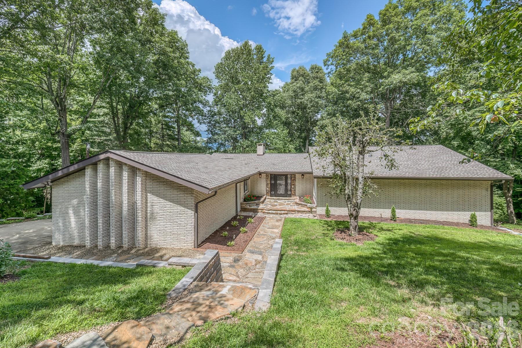 Come live in the heart of the Appalachian Mountains. All new cabinetry, granite, Viking appliances. Custom railings, 3 inch hickory, slate and travertine floors.  New Roof and new large Trex deck. The main level features a large living room with a fireplace, an eat in kitchen, dining room, three bedrooms and two full baths. Primary bedroom, laundry room and garage are on the main level. The downstairs features a large den, another fireplace, bedroom and full bath. There is a large 2-car garage on the main level and a utility/workshop in the basement area. Large windows to take in the beautiful mountain views, sitting at almost 3,000 ft elevation. Ride your golf cart to newly refurbished Grassy Creek Golf Course for a round of golf or a great meal at the clubhouse. This home is located within minutes of all High Country activities, just a short drive to Asheville, Boone or Johnson City, TN. Loads of wildlife; deer, rabbits, turkey, squirrels, etc. and an occasional bear! Welcome HOME!