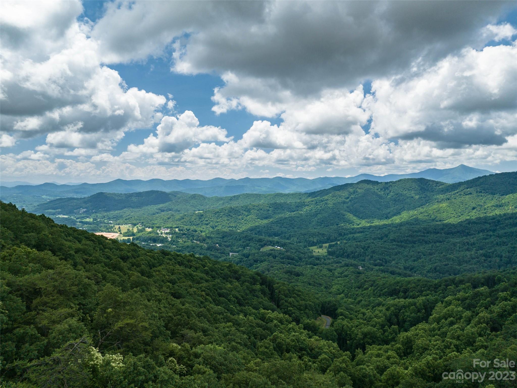 Stunning lot with a waterfall in desirable Western North Carolina - build your dream mountain home among the rhododendron and mountain laurel and look forward to enjoying an amazing view each day from your property. Paved roads lead directly to the lot granting easy access. The slope of the lot allows for magnificent long-range views – you can even see Downtown Asheville, the Biltmore Estate and Mount Pisgah. The Summit of Asheville offers a gated entrance, community garden and hiking trails and is located minutes from I-40 access, allowing for a quick drive to Asheville or Waynesville!