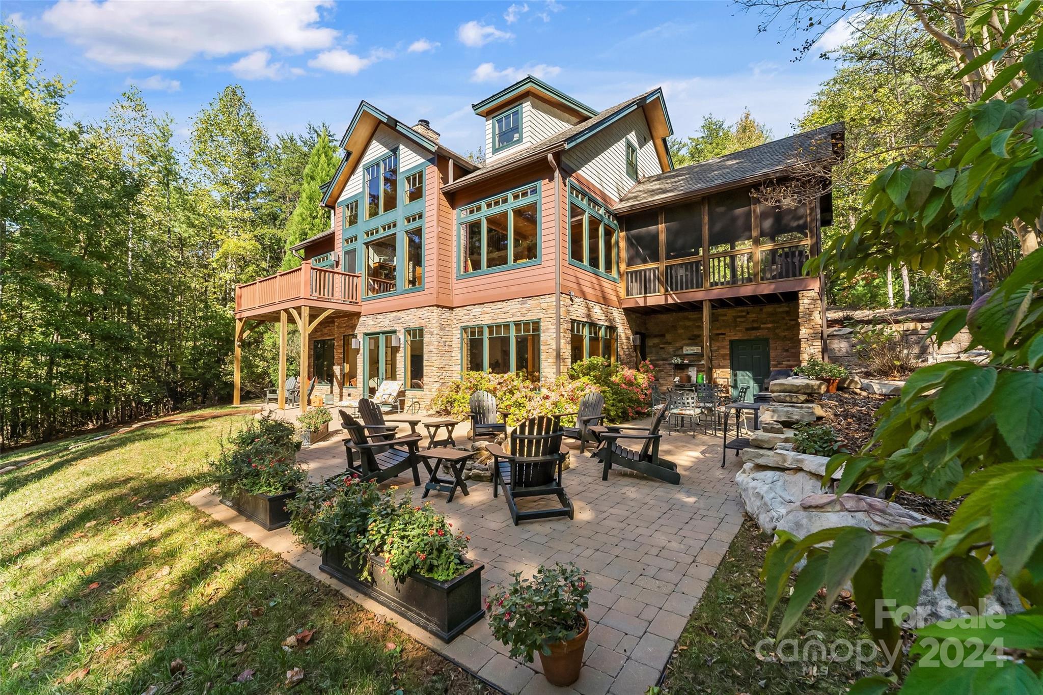 Beautiful waterfront Timber Peg home on 2+ acres.  Two story great room with large windows and beams provide warmth and light. Cozy great room with stone fireplace opens to dining area and updated kitchen.  Granite counters, a breakfast bar, SS appliances & large walk in pantry.  Side entry door to mudroom & laundry with sink and cabinetry.  Primary bedroom looks out over the lake with private deck, double closets, ensuite bath with large tiled shower, soaking tub & double sinks.  Upper level features two bedrooms with ensuite baths and a loft.  
Lower level has 4th BR with attached hall bath.  Spacious family room with wet bar overlooking the lake. Enjoy the fire pit and stone paver patio at ground level or take an easy walk to the lake where you'll find a private beach area, kayak rack, dock with lift and jet ski dock.  Water, power, Wifi and security cameras at the dock.  Large exterior entry storage area for lake toys.  2 car detached garage with  covered walkway to front porch.