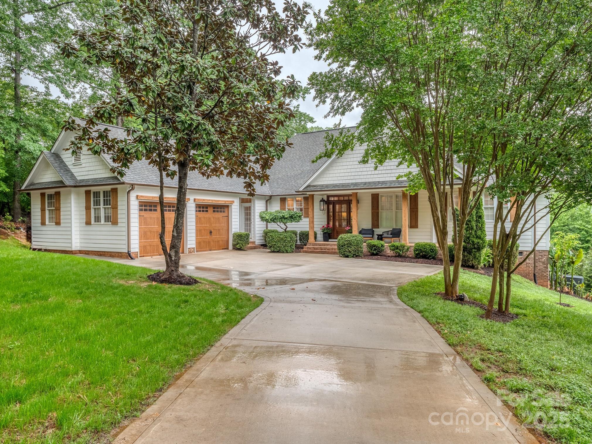 Dream ranch lake house w/ brand new renovated expansive kitchen & custom walk in master closet! WATERFRONT home on one of Lake Wylie's deepest coves, close to main channel, 20' deep at dock. NO HOA! Covered boat lift, floating dock, deck. Covered rear porch, deck & hot tub. Extensive interior renovations include stone kitchen countertops, sink & fixtures, custom cabs, lighting, under/over cab lighting, lighted floating shelves. Stainless steel appliances, Viking gas range, wine cooler, double oven. New tankless WH. Primary bath & w/in closet completely remodeled to the studs. Open floor plan, vaulted great room w/stone FP, generous dining area. Refinished hardwood floors. Permitted FOR 3 BEDS, 4TH IS AN OFFICE. New driveway, garage doors, front door, porch pillars & shutters, gas lanterns & exterior lighting, path to the water, and FULL WATERFRONT STABLIZATON of the .87 acre point lot. Beautiful established Catawba Crest neighborhood paved street. Photos & floor plan Friday 4/25.