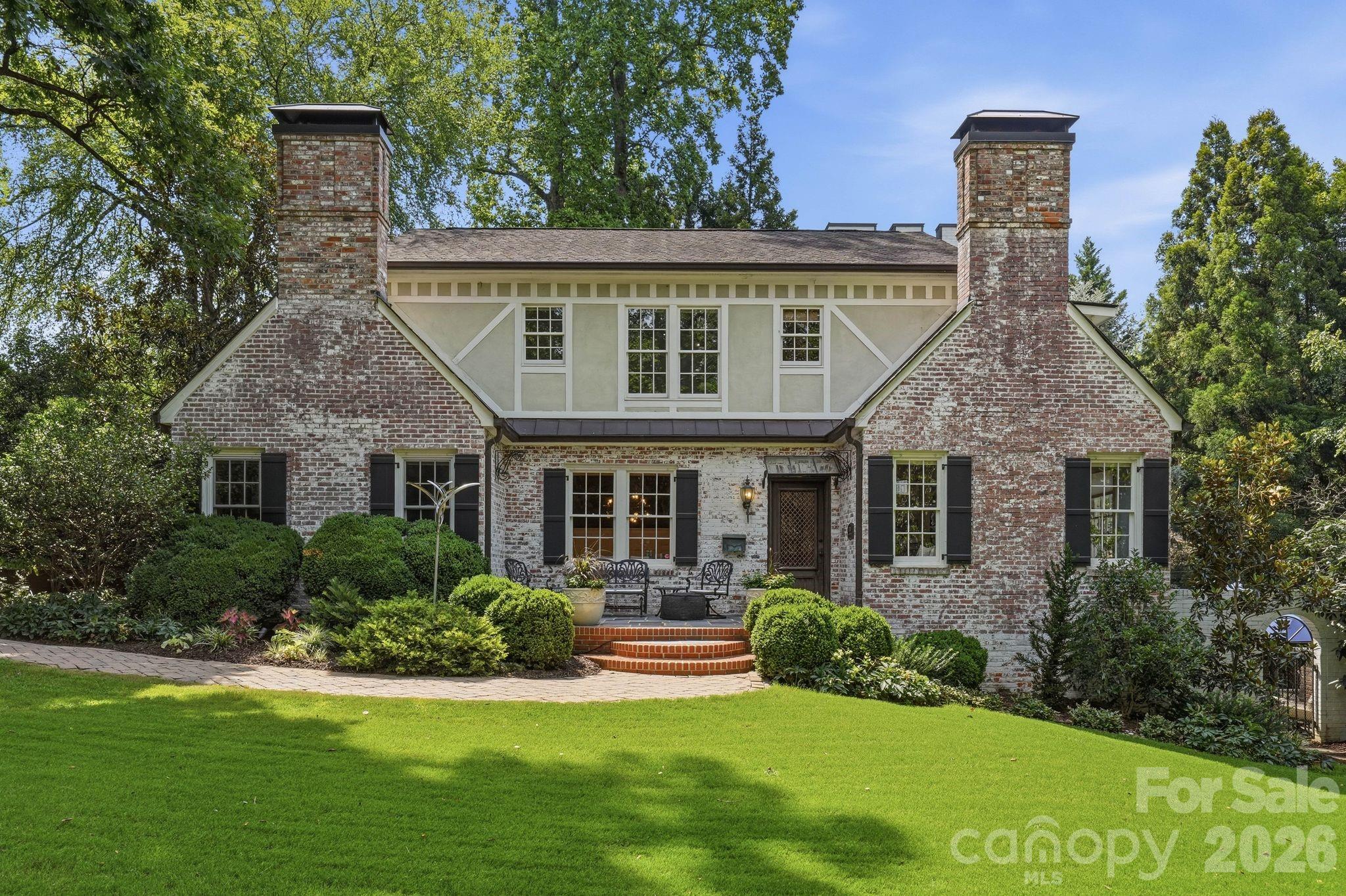 Within Plaza Midwood’s most exclusive enclave sits one of the neighborhood’s signature properties. Offering unmatched serenity & privacy within Charlotte’s urban core, this nearly .6-acre English Country estate embodies the character that defines Plaza Midwood.

Rarely do homes of this distinction come available in the shadows of Charlotte Country Club. Meticulously renovated by its two most recent owners, including a prominent Charlotte builder, 2700 Belvedere has been featured on the Plaza Midwood Home Tour, Home Design Decor and Southpark Magazine.

The vintage Parisian front door clad in Cast Iron sets the scene, while a custom Soapstone fireplace defines the spacious Living Room. Hand woven velvet wallpaper and solid wood wainscoting elevate the Dining Room. These spaces harken to the home’s heritage with the original wood picture molding and baseboards.

In the kitchen, thick slab Quartzite countertops accent the 48’’ Wolf Range and Sub-Zero refrigerator. Glance over the kitchen sink to your English Garden highlighted by a Koi Pond and mature landscaping. Two of the home’s five bedrooms round out the main living area. 

The upper level features a versatile bonus room with full bath that can serve as a bedroom, media area or additional entertaining space. Continue up the stairs to your nursery/office /5th BR with attached full bath and into the Primary Suite, highlighted by a massive walk-in shower & closet with dedicated washer/dryer. Sip morning coffee on the patio with the tranquil feel of the Koi Pond & Gardens.

The resort style outdoor space features a 20,000-gallon heated saltwater pool with swim jets & built-in hot tub. Relax on chilly nights in front of the outdoor wood burning fireplace while cooking on the built-in gas grill. 
Retire to your lower-level entertaining space and enjoy wine from the 148-bottle cellar in front of the gas log fireplace. 

Guest, tenant or multi-generational options abound with the 596 sq ft guest cottage, complete with kitchen, living, full bath, laundry, loft style bedroom & private patio.

2700 Belvedere offers the rarest of opportunities in Charlotte Real Estate; exclusive location, seclusion, unmatched space & designer curated finishes.