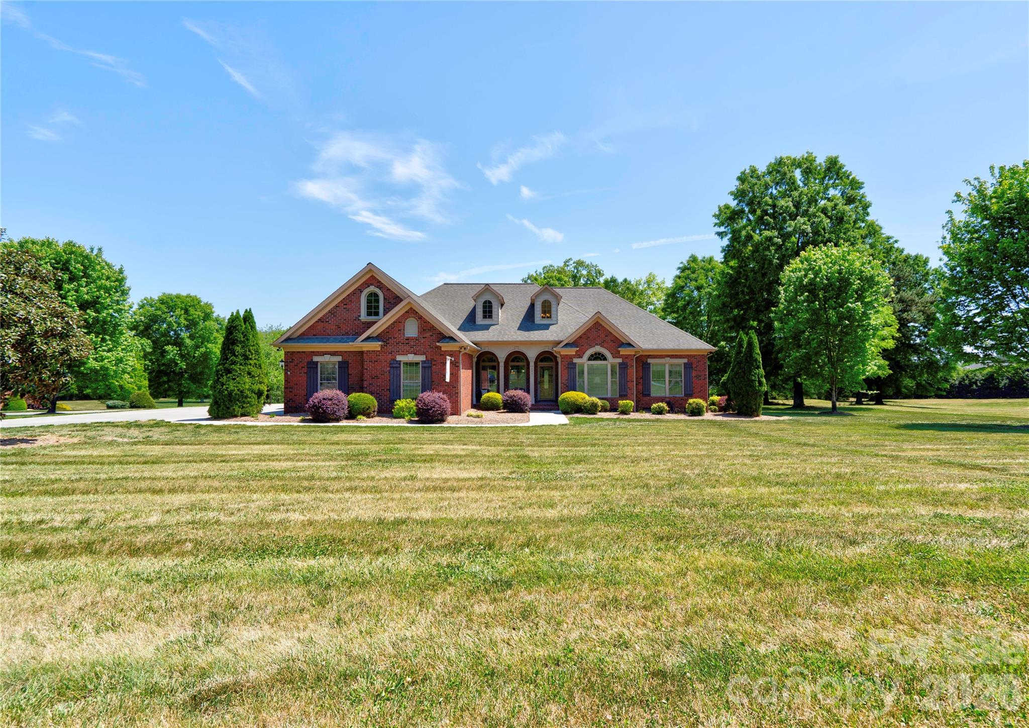 Gorgeous 3BR 2.5BA brick home on a corner lot in The Pointe subdivision near Moss Lake. This home has it all! Gleaming hardwoods. Vaulted ceilings & all others are 9'. Granite countertops. LR has vaulted ceiling & gas log fireplace. Custom kitchen with stainless appliances, granite counters pantry, breakfast bar & brick-like backsplash. Breakfast area & formal dining room with trey ceilings. Split bedroom plan. Large primary suite has vaulted ceiling, sitting area, huge walk-in closet, granite dual vanity with make-up desk, soaking tub, tile walk-in shower & water closet. Large laundry room with overhead cabinets & fold-down ironing board. Spacious office with vaulted ceiling. Bedrooms 2 & 3 each have walk-in closet & share a jack-n-jill bath with tile walk-in shower & granite counter tops. Large sun room has tile flooring & beaded board vaulted ceiling. Huge bonus room has a large walk-in closet and attic access. Home has a covered front porch (with tile floor), rear deck, rear patio & oversized triple garage. Main level of home has gas heat & the upper level bonus room has a heat pump. There are 2 electric water heaters. Home has a central vacuum & a security system. Refrigerator, washer, dryer, and living room TV remain. This home is truly a MUST SEE! Come make this your new DREAM HOME.
