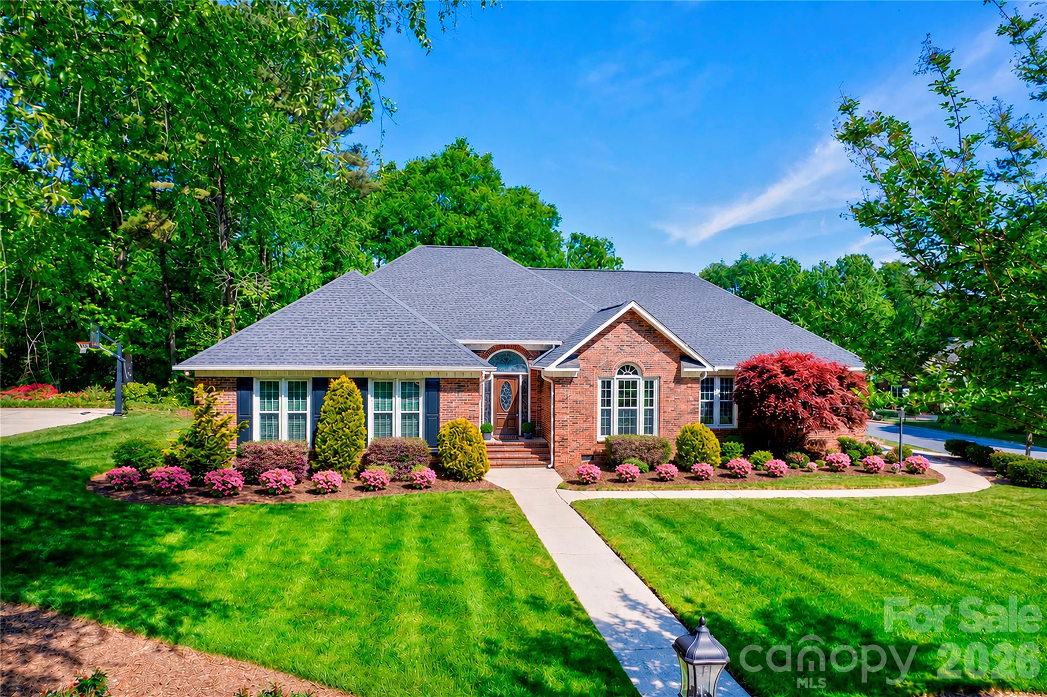 Located in the well-loved Carriage Downs neighborhood, known for its mature trees and spacious lots, this full brick ranch sits on a generous .57-acre corner lot and offers over 2,600 square feet of thoughtfully designed living space.

3 bedroom PLUS office/flex Space - The layout truly sets this home apart. Bedrooms are tucked to one side for privacy, while the main living areas sit at the heart of the home, and a separate office/flex space with a half bath is positioned on the opposite side near the garage—perfect for working from home or creating a quiet retreat.

The large family room serves as the centerpiece, offering plenty of space to gather and flexible options for furniture and use. It flows easily into the kitchen and dining areas, creating a natural connection for everyday living and entertaining.

The kitchen features granite countertops, abundant workspace, an induction electric stove (2025) and appliances replaced around 2018. Just off the kitchen, the dining area and sunroom are filled with natural light and offer a beautiful view of the backyard and outdoor spaces.

The living room includes a gas fireplace and provides a cozy but spacious setting, while still maintaining separation from the rest of the home. The office/flex space is a standout feature—complete with a door for privacy— or a fourth cozy bedroom.

The primary suite is generously sized with a tray ceiling, two closets, and a private bath with dual sinks, a large garden tub, and separate shower. Two additional bedrooms are spacious - additional full bath.

Additional features include energy-efficient triple-pane windows (2013), a screened porch with tile flooring tucked privately off the deck, LeafGuard gutters, encapsulated crawlspace with vapor barrier, tankless water heater, and a well-fed irrigation system with a newer pump and dual zones.

The roof was replaced in late 2023, and the interior has been freshly painted throughout (with the exception of secondary bedrooms). Built by Niblock, this modified Hawthorne plan offers varied ceiling heights and a comfortable, functional flow.

Neighborhood amenities include a clubhouse, pool, and tennis courts, all in a convenient location close to shopping, parks, I-85, and everyday essentials.

This is a home where the layout, natural light, and connection between spaces truly stand out!