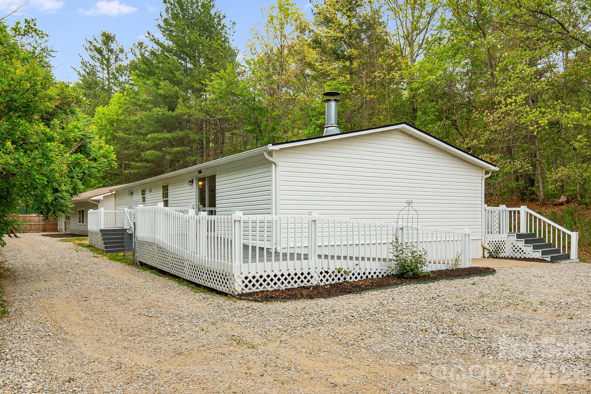 If you’ve been dreaming of mountain views, privacy, and a home that’s already been updated for you—this one is going to feel like the perfect fit.
Welcome to 90 High Point Road in Weaverville, where you’ll find a beautifully refreshed 3-bedroom, 2-bath home sitting on approximately 2 peaceful, wooded acres with stunning long-range mountain views that never get old. Whether it’s sunrise coffee or winding down at the end of the day, the scenery here truly steals the show.
Step inside and you’re greeted with a bright, clean feel thanks to fresh interior paint and brand-new luxury vinyl plank flooring. The layout is comfortable and functional, making it easy to settle in right away. The kitchen has been updated with a new appliance package and countertops, giving you a fresh, modern space to cook, gather, and entertain. Both bathrooms have been upgraded with new vanities, adding a simple but impactful touch of style. And with a brand-new roof already in place, you can enjoy peace of mind knowing the big-ticket items have been taken care of.
Outside, the freshly painted decks are ready for you to relax, host friends, or simply take in the quiet surroundings and incredible views. One of the standout features here is the large detached workshop, offering over 900 square feet of flexible space. Whether you need a garage, a place for projects, extra storage, or even a hobby space, this building opens the door to a lot of possibilities.
The location strikes a great balance—tucked away in a peaceful setting, yet still convenient to Weaverville, Mars Hill, and Barnardsville. You’re close enough to enjoy local shops, restaurants, and everyday conveniences, while still feeling like you’ve escaped to your own private retreat.
This is the kind of property that’s hard to find—updated, well-maintained, with land, views, and usable space both inside and out. It’s ready for you to move in and start enjoying right away.