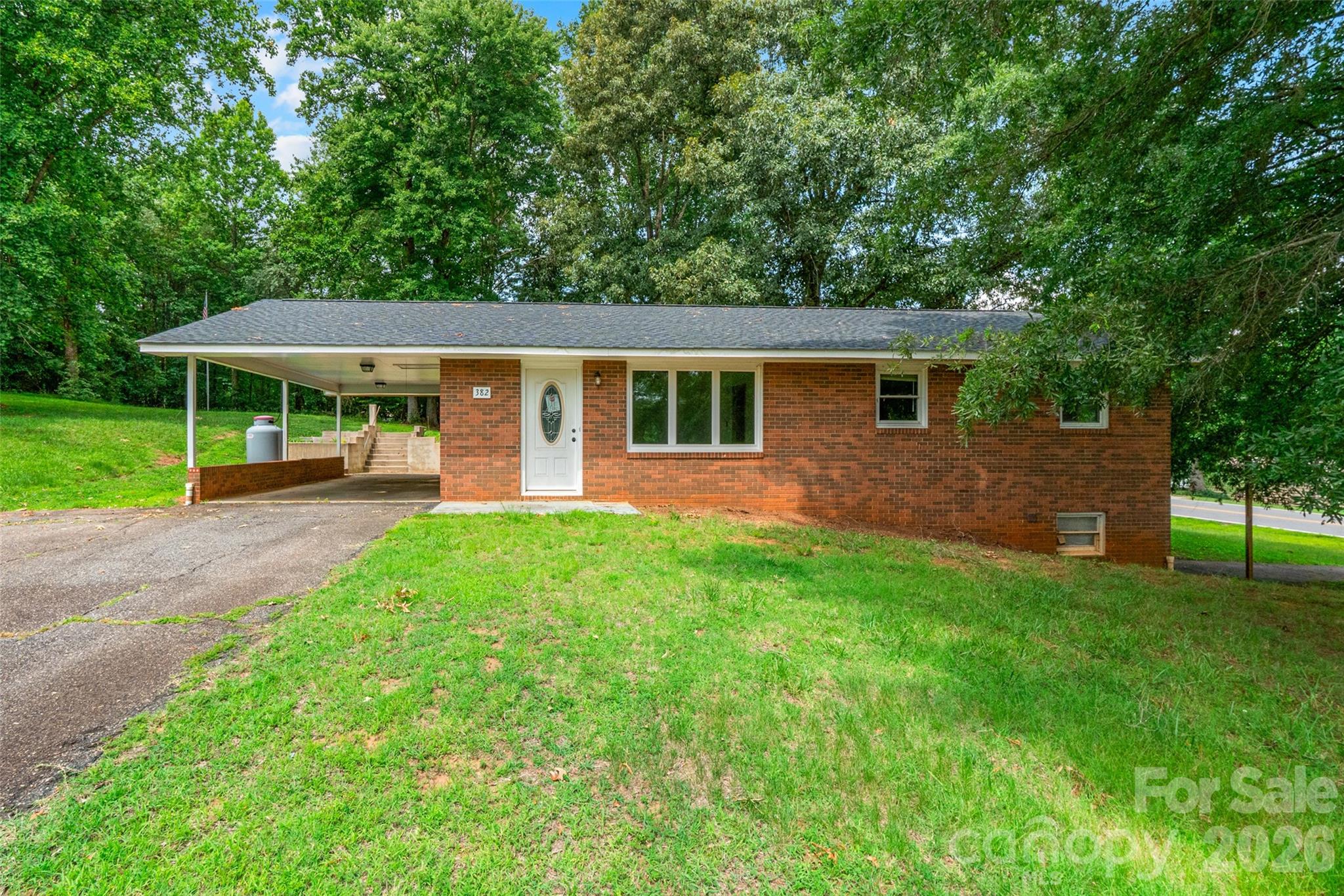 Welcome to this 3-bedroom, 2-bath brick ranch home offering a functional layout. Inside, you'll find a spacious living room, a generously sized kitchen with ample cabinet and counter space, and a dining area with access to the backyard. The bedrooms offer ample space, and the home provides a great opportunity to add your own personal style and updates over time. The full unfinished basement offers abundant storage, workshop space, or the possibility for future expansion. Outside, enjoy the large backyard with mature trees, a spacious patio, and a covered carport. Conveniently located near shopping, dining, schools, and everyday conveniences, this home is ready for its next chapter.