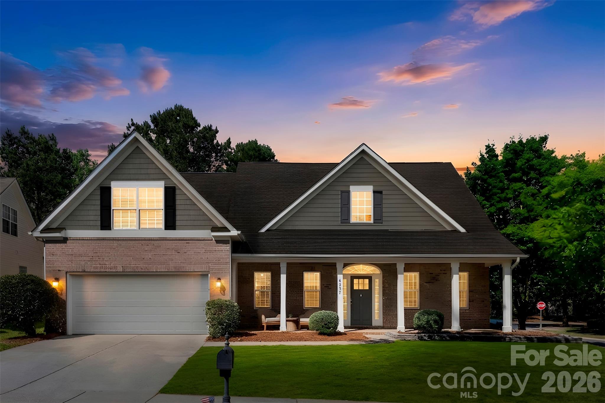 Beautiful home featuring a spacious primary suite on the main level. Step inside from the large covered front porch into a stunning two-story foyer filled with natural light from abundant windows. The formal dining room showcases elegant crown molding, wainscoting, and a stylish chandelier. The inviting living room is ideal for relaxing or entertaining, highlighted by a vaulted ceiling and cozy gas log fireplace. The kitchen opens seamlessly to the living area and includes a large bar area, gas range, double stainless steel ovens, and built-in microwave. The spacious breakfast area overlooks the private, tree-lined backyard. The main-level primary suite offers a tray ceiling with ceiling fan and a charming bay window with peaceful backyard views. The luxurious primary bath features dual vanities, a large soaking tub, and separate shower. A secondary bedroom on the main floor offers neutral décor and convenient access to a full bath. Upstairs, you’ll find a generous guest bedroom, open loft area, and a versatile bonus room perfect for an entertainment or recreation space. Residents enjoy exceptional neighborhood amenities including two pools, walking trails, recreation areas, playgrounds, basketball courts, tennis courts, and pickleball courts.