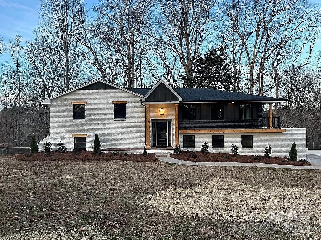 Welcome to your serene country retreat. This remodeled brick home offers the perfect blend of modern convenience & rustic charm. The open concept main floor is flooded with natural light, a spacious living room w/ French doors that open to a patio balcony.The Kitchen boasts new custom maple cabinets & large island. This split level gem offers 2 bedrooms on the main floor, including a luxurious primary suite w/ a cozy brick wood burning fireplace. The primary bath has a tiled walk-in shower & spacious walk-in closet for added convenience. Also on the main floor you will find a 2nd full bath with tiled shower/tub combo & a laundry room. The lower level has a versatile space perfect for entertaining or relaxing with a craft burning wood stove, wet bar, private bedroom w/ full bathroom and a 2nd laundry room equipped w/ built in cabinets & direct access to the garage. Outside, a fully fenced in backyard offers a private retreat. Minutes from i85, crowders mountain & the new casino.