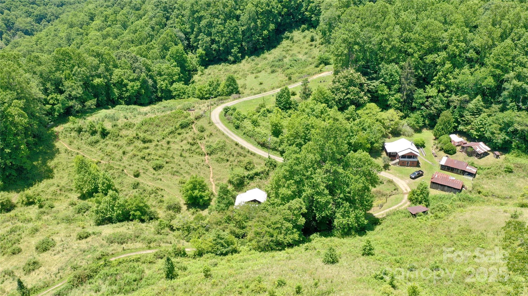 16+/- unrestricted acres at 2800 feet in elevation with pastures and a house! At the end of Henry road sits an opportunity to own a great piece of land with lots of options. The property would be great for horses, cattle and farming. There are several outbuildings and fenced pastures and a barn. The power has been turned off and to get it turned back on there has to be proof of septic disposal. The siding on the house appears to be asbestos. There is an approximate half acre cemetery at the beginning of the property which is not part of the property. There are right of ways over the property to get to the neighboring property. Seller has never lived on the property. There are quite a bit of things in the outbuildings left by the previous owner. The house has not been lived in for several years and there is no record of septic.  There has been a recent septic inspection and it was revealed that no septic tank or drain field was found and a high probability it was piped into the creek.