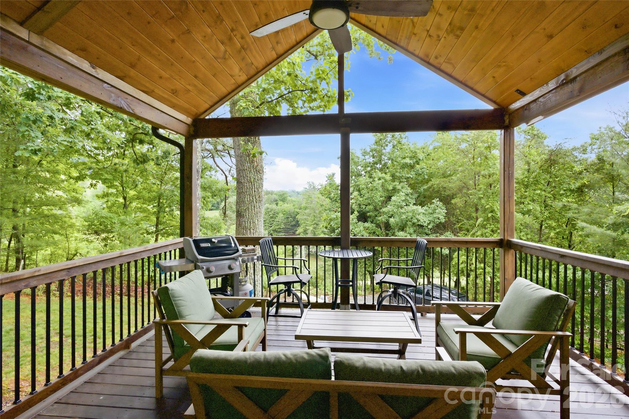 Some houses you tour and forget. This isn't one of them.

Built in the Arts & Crafts tradition and finished like a showroom, this mountain home delivers year-round views, indoor-outdoor flow, and the kind of craftsmanship that's genuinely hard to find at any price point. The wraparound covered deck and custom lower patio make the mountains feel like your backyard — because they are.

Inside, vaulted ceilings and walls of windows pull the scenery in. The stacked stone fireplace grounds the living room while the kitchen earns its keep — custom wood cabinetry, a handcrafted backsplash, and an island that actually fits people around it. The primary suite is its own retreat: barn door closet, dual vanities, tiled walk-in shower. A loft overhead works equally well as an office, studio, or spillover guest space.

Downstairs functions as a fully independent level — family room, kitchenette, game area (pool table included!), bedroom, full bath, and its own entrance. Guests, rental income, or multigenerational living: the options are there.

The garage runs workshop-sized. And all of it sits 25 minutes from Asheville. - See this one before someone else does!