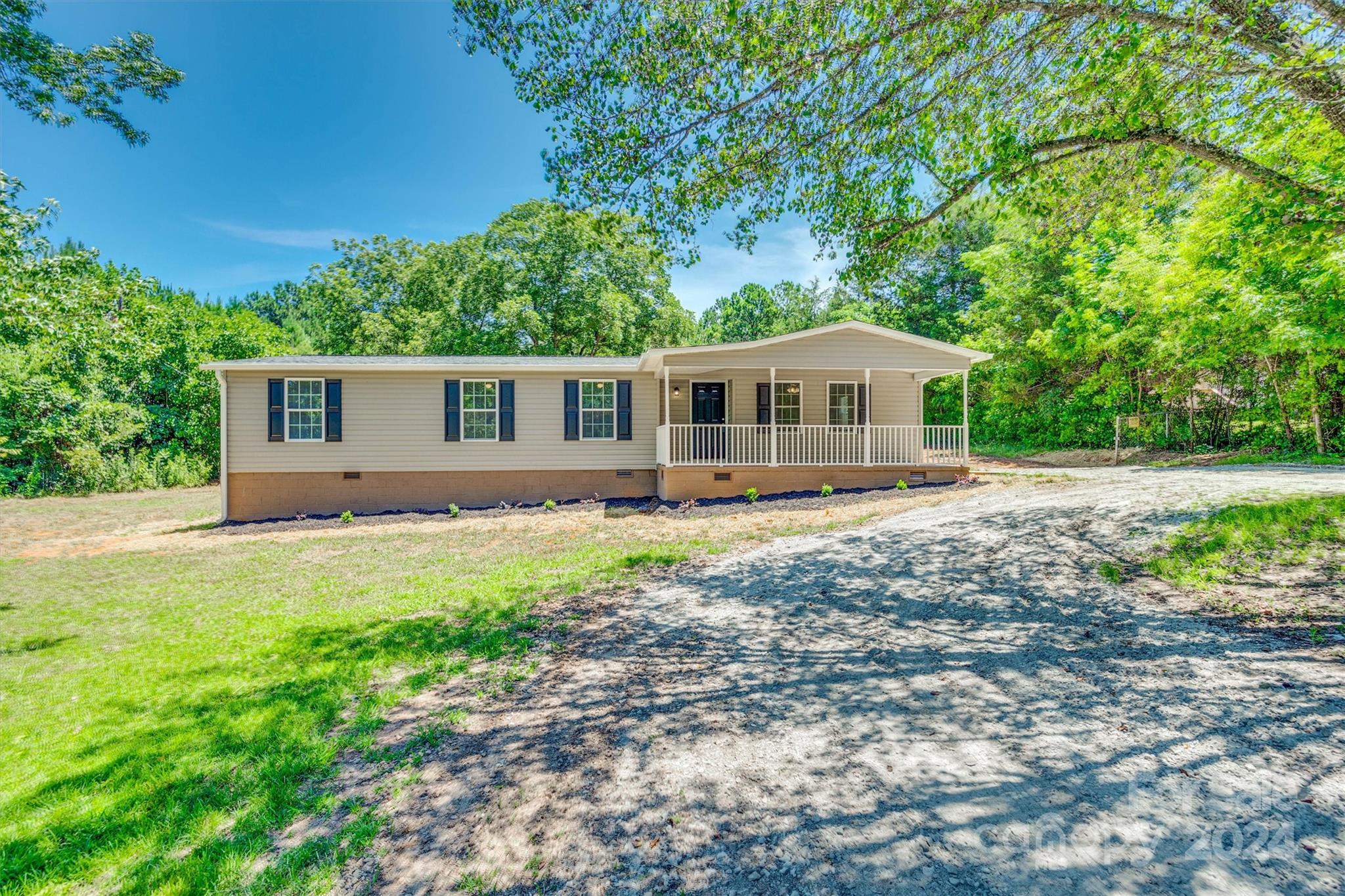 Nestled in a rural setting, this three-bedroom, two-bathroom updated ranch home offers a perfect blend of modern comfort and country charm. Situated 1.64 acres, the property offers  an updated like new condition. It is move in ready with lots of new features: a new roof, new siding, and a spacious new deck perfect for outdoor relaxation. Inside, the home features new light fixtures, appliances, toilets, and bathroom fixtures, as well as fresh flooring, carpet, and doors throughout. Clean as a whistle and brimming with updates, this home promises a peaceful and worry-free living experience. NO HOA.