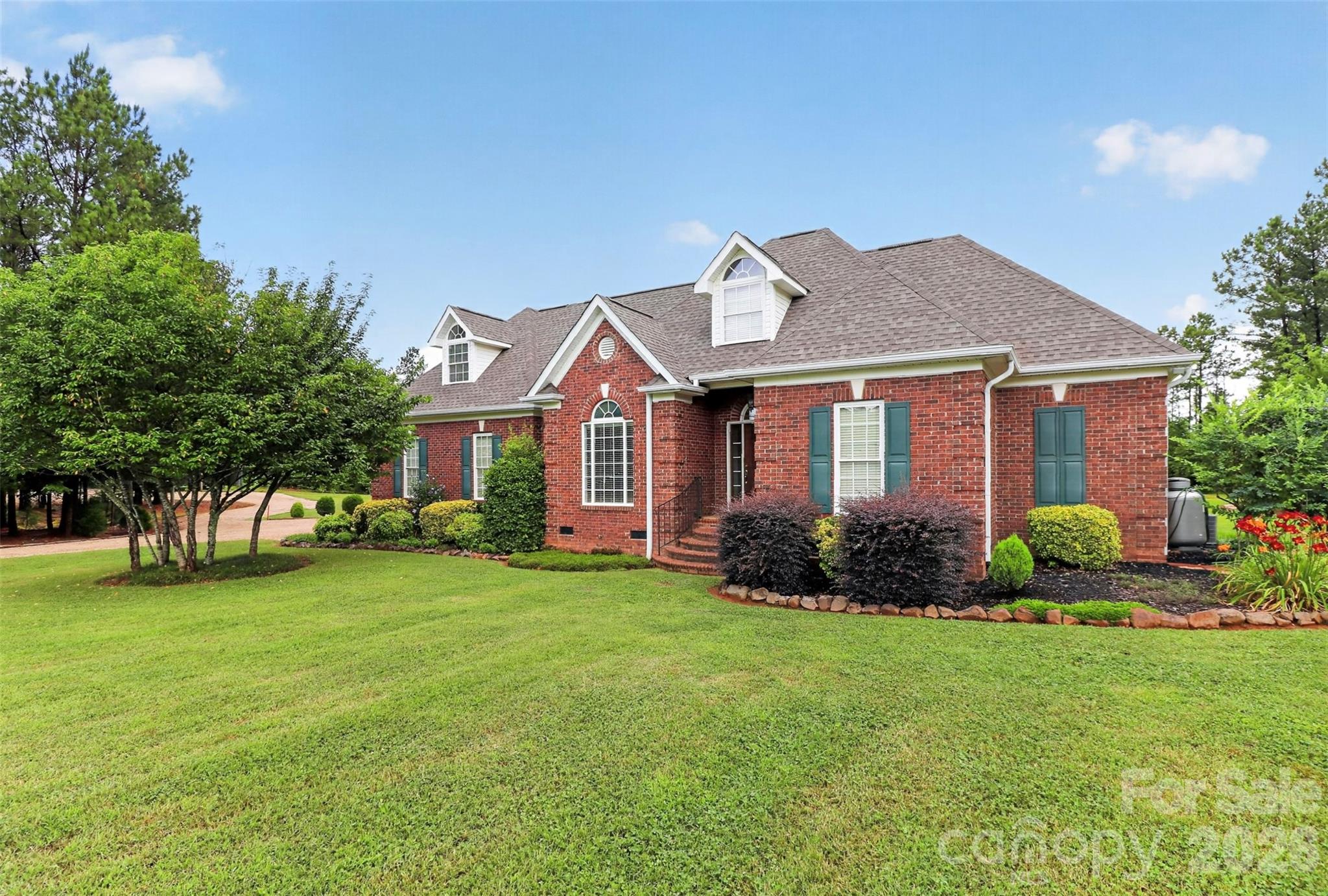 Stunning all brick home with 23 acres and small pond .  A spacious 3 bedroom, 2 bath home with 9 foot ceilings, Gas fireplace in family room, bonus room.  back porch overlooks pond.  Double garage.  - Property features a wired and plumbed shop building with over 1880 sq ft. The building features a tandem parking for four vehicles, shop, laundry/storage room, office, kitchenette, and a bathroom.  Building has a loft with access to a floored attic and an adjacent shed (approximately 20 x 20)  A gem in the country!