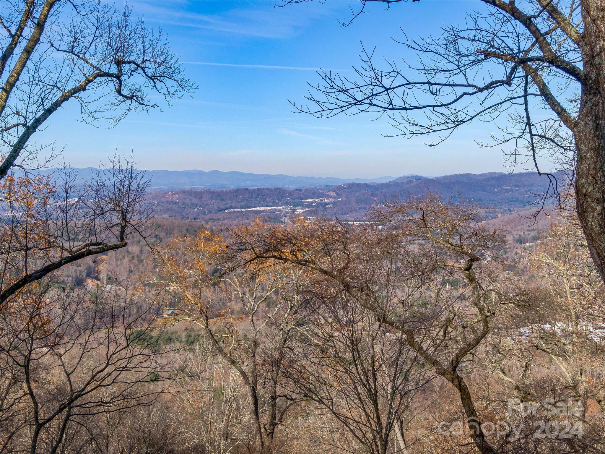 SPECTACULAR ASHEVLLE VIEWS! These are the last 2 lots available that the developer has kept in the family. Easy drive to property on paved, private road, in coveted gated Ridgeview Estates. Build your mountaintop dream, just minutes to Asheville and the Blue Ridge Parkway! Enjoy the glorious changing Seasons with sweeping layered views of the Blue Ridge Mountains and the magical twinkling lights of downtown Asheville! There are 2 home builds possible or keep the nearly 11 acres for yourself! Several build sites to choose from all with majestic views, lush woods and privacy. House plans available - Must see!!