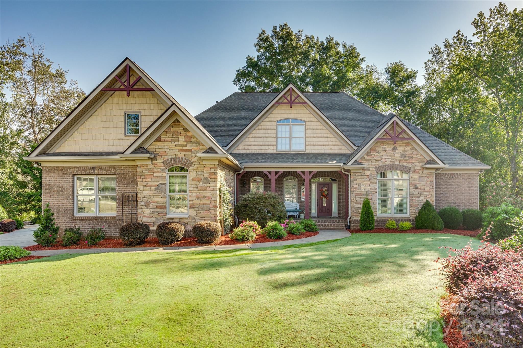 This custom-built home impresses with high baseboards, crown molding, wainscoting, and a coffered ceiling in the great room. The landscaped backyard borders a greenway for privacy. The dining room connects to a gourmet kitchen with custom cabinetry, granite countertops, gas cooktop, and pantry. Adjacent is a keeping room with a gas fireplace, French doors to the deck, and a breakfast nook leading to a screened porch. The great room features a granite fireplace and large windows facing the yard. An office or 5th bedroom with full bath is near the entrance. Owner’s suite includes a sitting area with deck access, spa bath, and custom closet. Upstairs, a media-wired landing connects to a guest suite, two bedrooms with a Jack & Jill bath, and attic access. The mostly finished basement offers recreation space and storage. The 3-car garage has an epoxy floor. Located 25 minutes from Charlotte and the airport, Fort Mill offers top-rated schools, dining, and a 2,100-acre greenway.