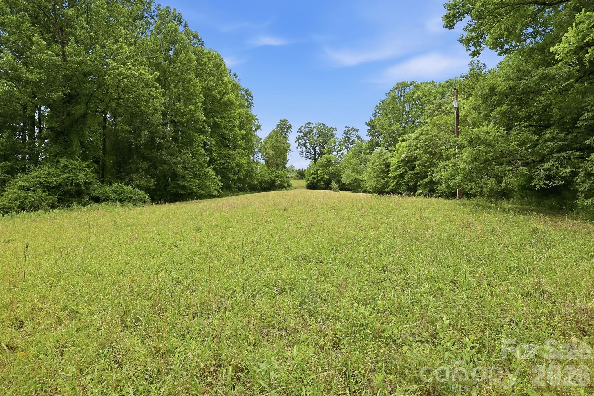 If you have been looking for a homestead or gentle building site close to Brevard, this is it. It has a creek, very gentle topography, and some of it is already cleared. And there is no HOA! It is a fantastic place to build a house or start your mini farm. You will have plenty of room to spread out on the 2.8 acres, and the lay of the land gives you more privacy and buffer than most parcels of a similar size.
There is already a well and septic in place from a previous mobile home, which puts you months ahead on site development. Build your dream home or set up a mini farm or homestead. The stream running along the property is a wonderful bonus as well.
No HOA. No known restrictions. No zoning. And easy access for a driveway.
The location cannot be beat. You are just a few minutes drive to downtown Brevard, but without the hustle and traffic. It sits on a quiet country road and is a perfect location for waterfalls, hiking, mountain biking, or whatever activities you love most. This is the type of location where you can have your quiet acreage but it's just a short drive to groceries and restaurants. 
This lot offers cleared land, mature woods, a creek, utilities, and lots of freedom on how you use it. Land like this do not come along often in Brevard! This is a 2.8 acre portion of 381 Pole Miller Extension. The subdivided plat has been recorded and should have a new pin number soon. But as of listing date, GIS mapping has not been updated and tax value has not been updated. Tax value in GIS reflects the value of a larger parcel with a home on it.