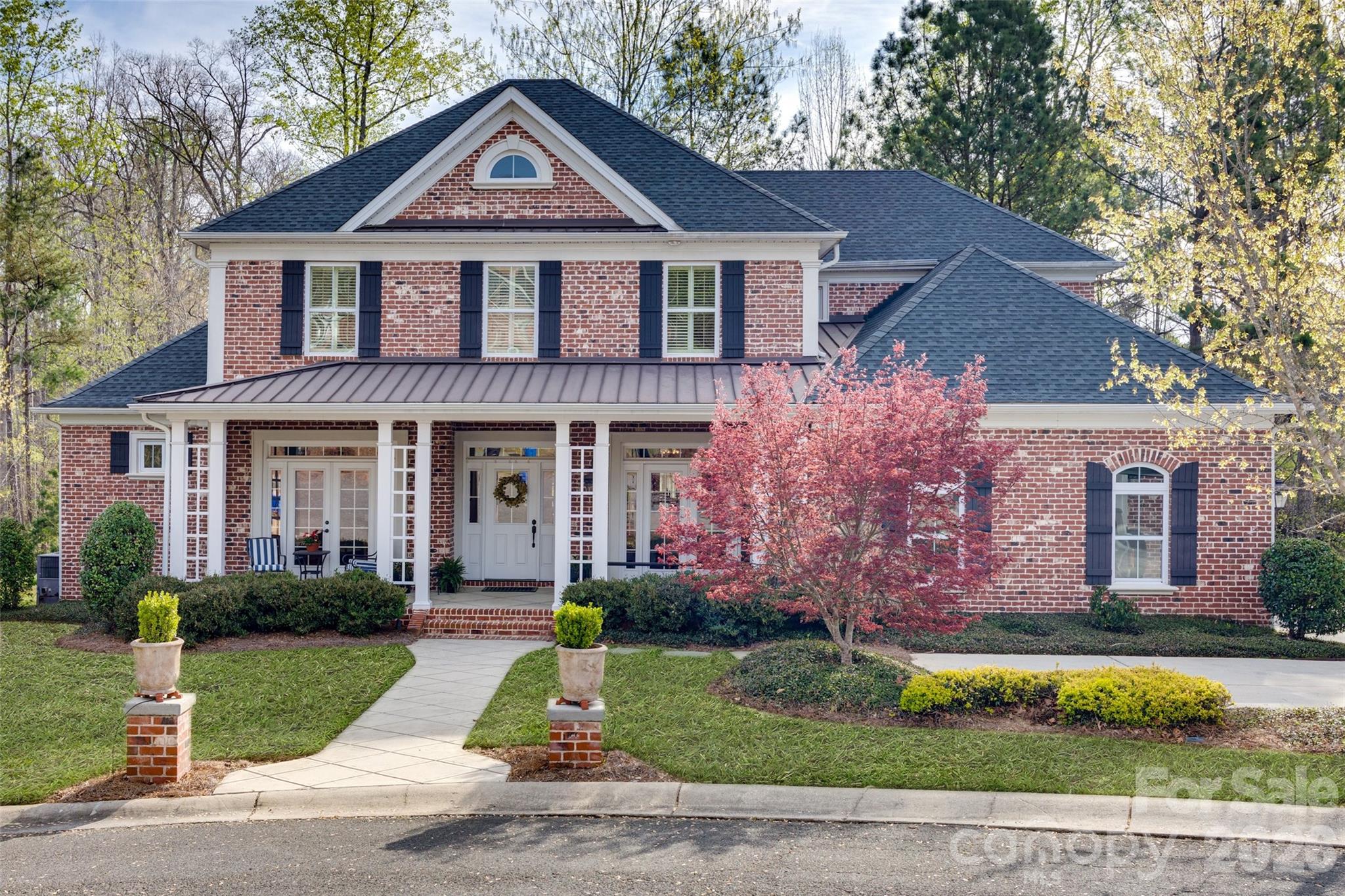 If you’ve been searching for an all-brick, thoughtfully designed forever home in the highly sought after neighborhood of Harlinsdale, this is it. Every faucet, knob, paint color, countertop and light fixture has been hand-selected by a local interior designer, lending a cohesive, warm, and welcoming mood to this home. Adapted from a Southern Living floor plan, this custom-built property was intentionally built for hosting large groups. Whether you’re in the formal dining room, at the oversized island, in the eat-in kitchen, or on the expansive deck, there’s a dedicated space for all while still feeling connected. Everyone knows the true heart of the home is the kitchen and this one doesn’t disappoint. With durable quartzite countertops, double-sided island, under cabinet lighting, gas cooktop, ceramic tile backsplash, discreet microwave, and eat-in dining, every detail adds beauty and purpose. The main-level primary suite features built-in bookshelves, dual vanities, a walk-in closet (with a closet system!), a tile shower, plus a tucked-away outdoor shower with blooming jasmine. The main level also provides a secondary primary suite (perfect for guests), and separate office with a gas log fireplace. The living room has 10’ coffered ceilings and both indoor and outdoor fireplaces are wood burning with gas starters, making fire-starting a snap. The upstairs has an additional three bedrooms, a bonus room, and a secondary living room we’ve deemed “the movie room” with its built-in projector and screen. The home rests in a cul-de-sac with surrounding trees and serene access to a delicate stream. This incredible home must be seen in person to truly experience its beautiful construction. Note: Harlinsdale residents may pay for access to neighboring Laurel Creek's community pool.