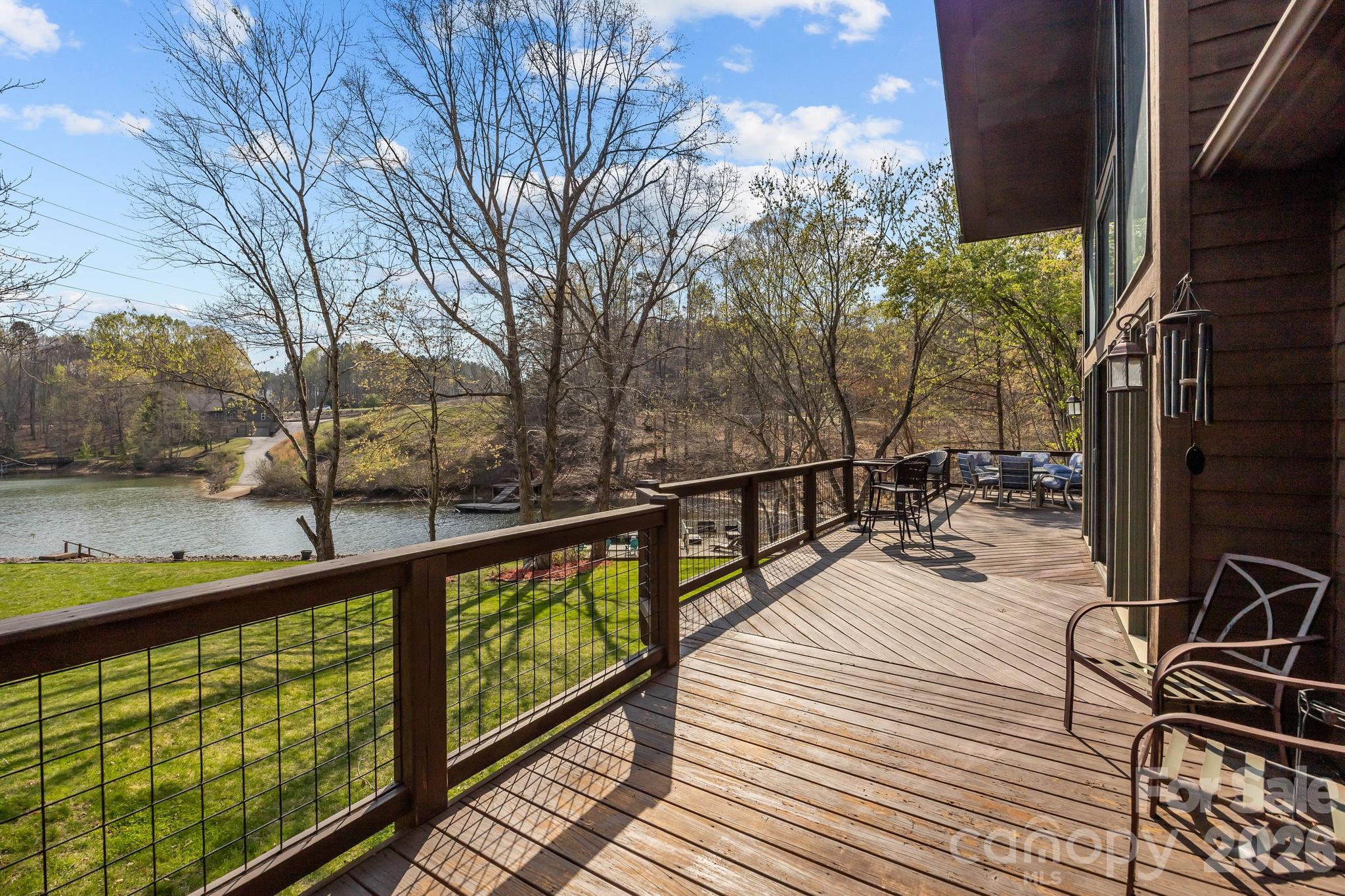 Welcome to 307 Stillwater Road, a quintessential Lake Norman retreat situated on a sprawling 1.28-acre lot where luxury and functionality live in perfect harmony. Located just moments from the natural beauty of Lake Norman State Park, this custom waterfront home is meticulously designed to showcase stunning panoramic vistas. Upon entry, the home’s warmth is immediate, highlighted by soaring A-frame windows, rich wood flooring, and a magnificent stone fireplace flanked by custom built-ins. The residence offers a rare and highly sought-after layout featuring two primary bedroom en-suites...one conveniently located on the main level and another on the walk-out lower level. This dual-primary design, paired with a stone fireplace on each floor, creates an ideal environment for multi-generational living, hosting long-term guests, or simply enjoying a private sanctuary on every level.

The seamless interior flow leads to an over-sized deck, an expansive outdoor sanctuary perfect for summer cookouts or peaceful morning reflections overlooking the water. For the hobbyist or lake enthusiast, the property includes a huge storage area with double access doors, providing the perfect space for water toys, workshop tools, or seasonal gear. Extra parking or storage available in the 20x24 outbuilding with bay door. A gentle path leads to your private, custom-built Lancaster dock complete with a boat lift. For those with four-legged friends, a small fenced side yard or a green thumb, the small fenced side yard provides a secure, manageable space without sacrificing any of your panoramic lake vistas. From the cozy fireside nights to the sun-drenched days on the boat, this property offers a rare opportunity to enjoy the very best of lakeside living on a significant piece of land.