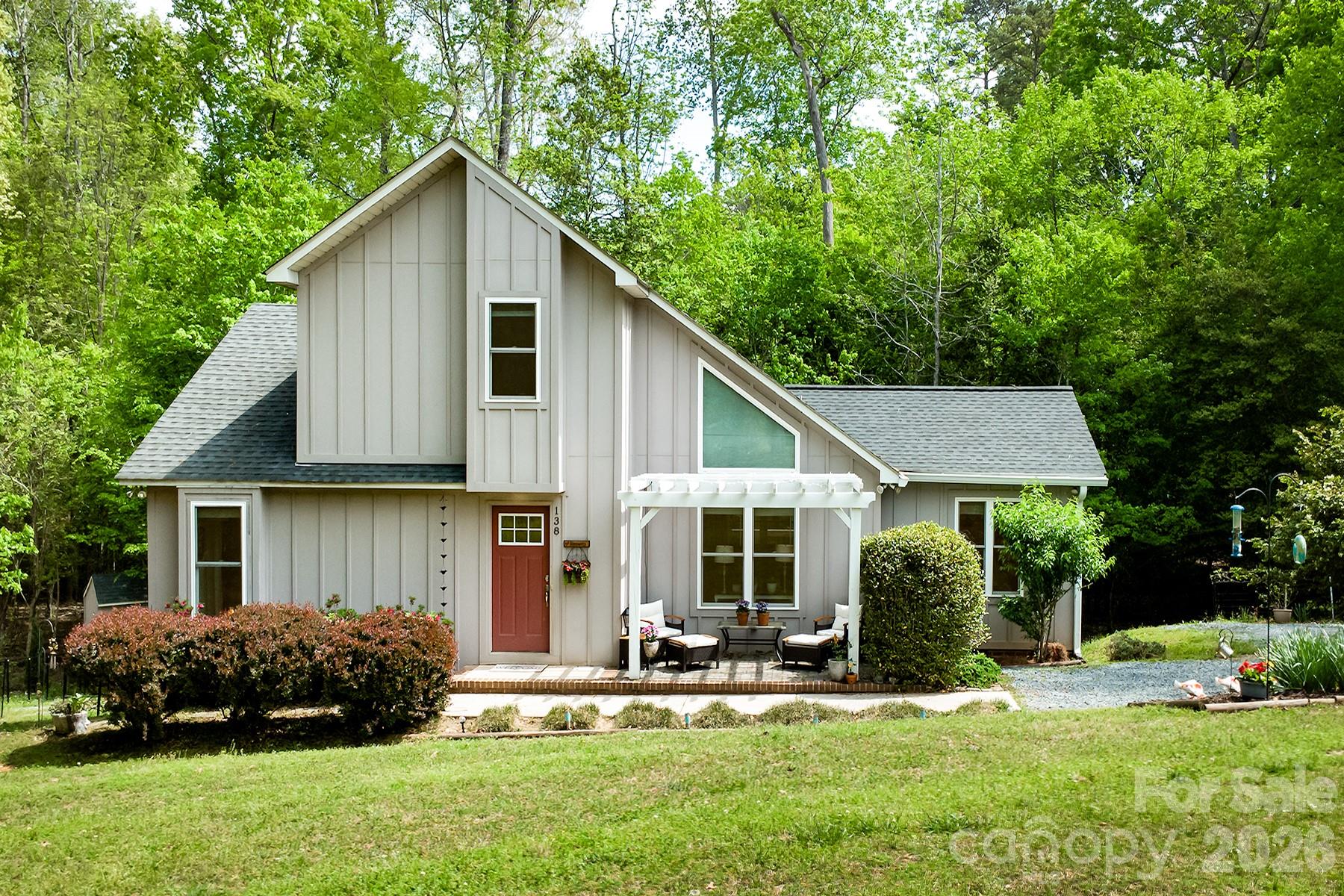 Tucked away on a quiet cul-de-sac in the Enchanted Forest of Woodrun, this charming custom-built home offers comfort, privacy, and a true connection to nature. Surrounded by mature trees and lush landscaping, 138 Uwharrie Court is a peaceful retreat just moments from Lake Tillery.

Inside, the open-concept living and dining area features a vaulted ceiling, abundant natural light, and a cozy fireplace—ideal for everyday living or entertaining. Gorgeous wood floors run throughout the kitchen, den, great room, and dining area. The thoughtfully designed kitchen flows seamlessly into the main living spaces, while the sunroom offers a bright, relaxing space to enjoy the wooded setting year-round.

The home includes 2 bedrooms plus a versatile flex room perfect for an office, guest space, or hobbies. A separate den with cathedral ceiling and mini-split adds flexibility. Additional features include Hardie board and batten siding, tankless propane hot water heater, tile shower in the primary suite, ample parking, and an abundance of storage in the large standup encapsulated crawlspace and outdoor shed.

Outdoors, enjoy a tranquil koi pond and multiple spaces designed for quiet mornings and peaceful evenings.
Located in the gated Woodrun community with amenities including a pool overlooking Lake Tillery, tennis/pickleball courts, basketball court, clubhouse, playground, and boat ramp. Boat slips and storage available for lease (waitlist), and short-term rentals are allowed.

Convenient to Morrow Mountain State Park and Uwharrie National Forest for hiking, biking, camping, and trail riding, as well as the nearby towns of Albemarle, Norwood, Badin, Mount Gilead, and Troy for dining and shopping. Lake Tillery also offers waterfront dining and multiple marinas.

Enjoy the tranquility of lake living with convenient access to Charlotte, Winston-Salem, Raleigh, Durham, Pinehurst, and Greensboro.

138 Uwharrie Court is a cozy, lake retreat that feels straight out of a storybook.