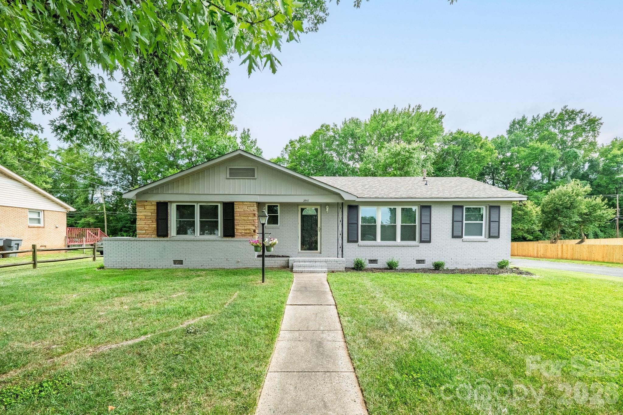 Welcome home to this charming, thoughtfully updated 3-bedroom, 1.5-bath residence perfectly situated on a spacious corner lot. Combining modern updates with timeless character, this move-in-ready home offers comfort, convenience, and exceptional value.  Step inside to discover fresh paint, NEW luxury vinyl plank (LVP) flooring, and an abundance of natural light streaming through the oversized living room window, creating a bright and inviting atmosphere. Nearly every major feature of the home has been updated, giving buyers peace of mind. Enjoy a brand-new roof (2026), newer appliances that will convey with the home, fresh interior finishes, and updated flooring throughout. The kitchen features beautifully painted blue cabinets that add a pop of personality while preserving the home’s original charm.  The spacious sunroom offers the perfect place to relax with your morning coffee, create a home office, or entertain guests year-round. You’ll also appreciate the ample closet space, accessible entry ramp, and large backyard with endless possibilities for outdoor living, gardening, or play.  Location is everything, and this home delivers. Conveniently located just a short drive from Uptown Charlotte and Charlotte Douglas International Airport, you’ll enjoy easy access to dining, shopping, entertainment, and travel.  This beautifully refreshed corner-lot home is ready to welcome its next owner!  Professional will be uploaded 07/21/2026.
