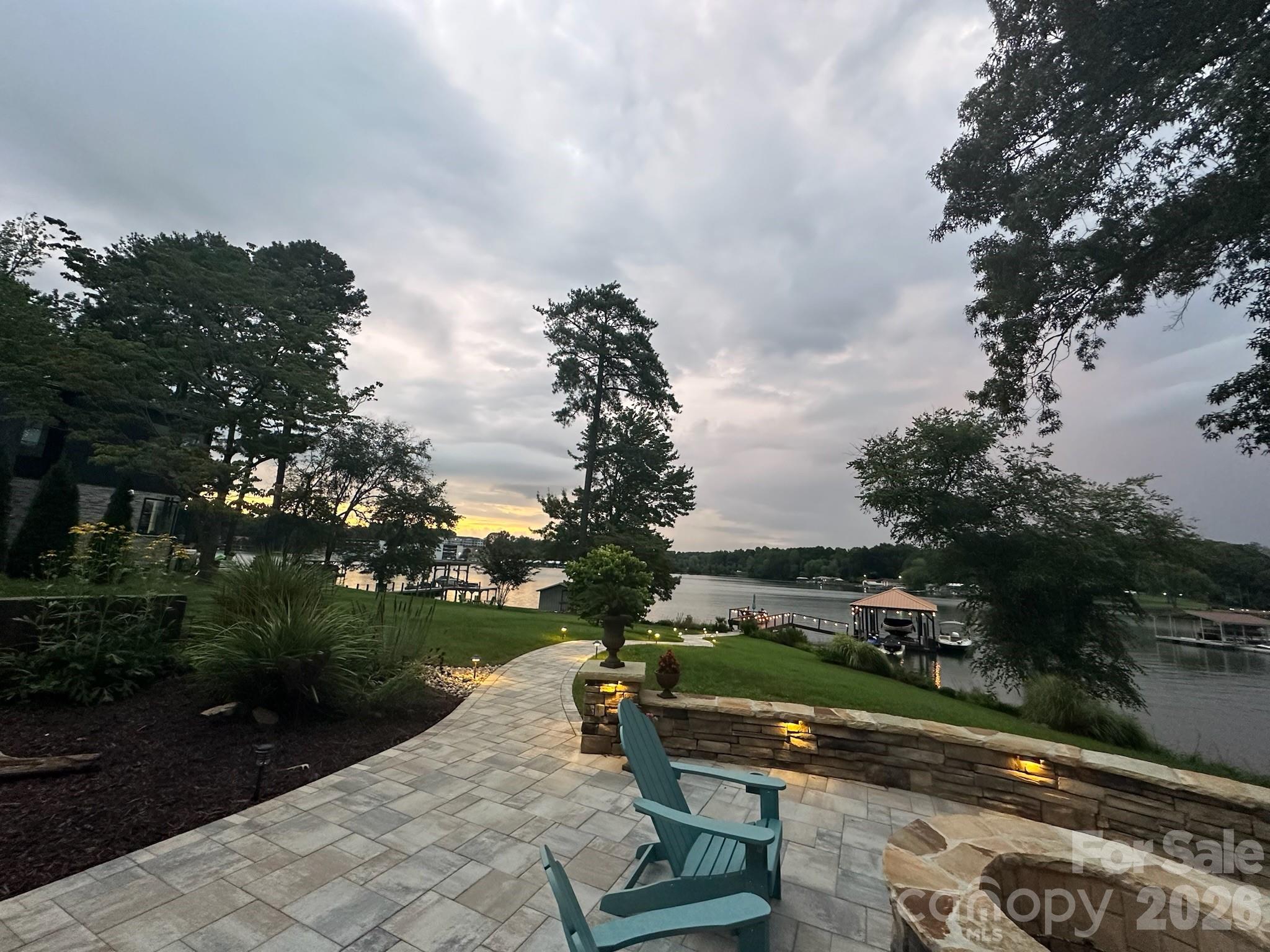***Price Improvement*** Experience waterfront living in this exquisite home, nestled on a private lot, offering a harmonious blend of modern luxury & natural beauty. Gleaming floors throughout add warmth & sophistication. The heart of the home is its expansive living area, where the kitchen, dining area, and living rooms flow together. Indulge in your primary suite, a private sanctuary with its large, spa-like shower, dual vanities with ample storage & custom closet. Enjoy breathtaking views of Lake Norman from many vantage points throughout the home. The lower level, newly constructed, includes a second kitchen, media/billiards room, wet bar, fitness room, a spacious Bedroom & and private living quarters/in-law suite. Discover a luxurious backyard paradise with a stone firepit & hot tub terrace ideal for outdoor dining or relaxing with serene views.