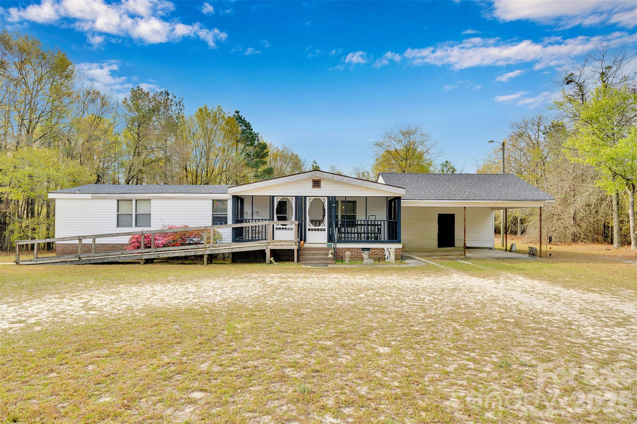Enjoy peaceful country living in this charming 3-bedroom, 2-bath home situated on nearly an acre of land. Relax on the inviting screened-in rocking chair front porch and take in the quiet surroundings. The wooded lot provides a private backyard setting perfect for entertaining, gardening, or simply unwinding in nature. The home also features a newer roof and HVAC system, offering added peace of mind for years to come. If you're looking for space, privacy, and the charm of country living, this property is a must-see. Low SC and no HOA!!