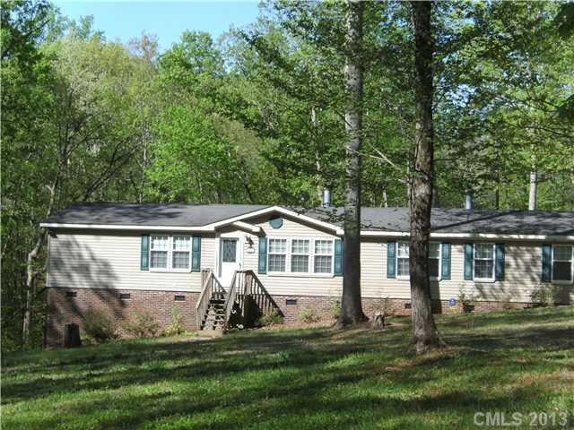 Just REDUCED!   Privacy abounds, yet close enough to everything!  Over 10 acres with hardwoods and stream.  Open floor plan featuring vaulted ceilings, 2 fireplaces, living room and den.  Dining room!  Large deck and Den overlook woods as far as you can see.  Storage building.  4 bedrooms!  Huge master suite with additional sitting room. This is a modular.  Call for more details!