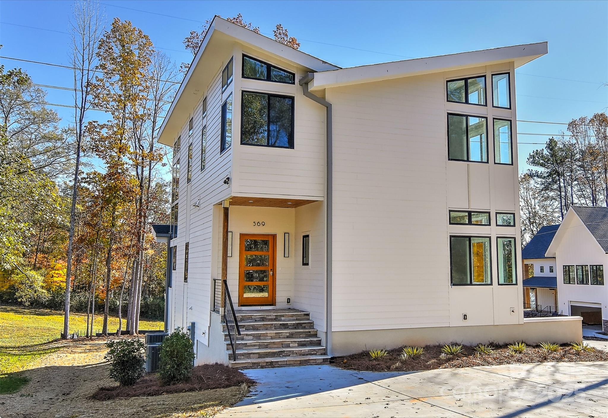 Discover modern luxury living with this stunning new construction home, conveniently located on a quiet deep-water Lake Wylie cove just minutes from the Boyd bridge.  This architectural masterpiece features sleek, contemporary design elements that blend seamlessly with the natural surroundings.  Floor-to-ceiling windows with soaring ceilings and rooflines offer breathtaking views of the lake, while open-concept living spaces provide an airy light filled home.  State-of-the-art kitchen boasts high-end appliances and minimalist finishes, ideal for casual living and sophisticated entertaining.  Expansive deck areas allow indoor-outdoor living.  Private dock area allows you to build your own dock for boating and waterside gatherings.  Ground floor features a potential in-law/guest suite/laundry with private entrance.  The main floor and upper floor offer multiple bedroom/flex room areas, with magnificent views. Upgrades throughout, closet systems, hot water recirculator and more!