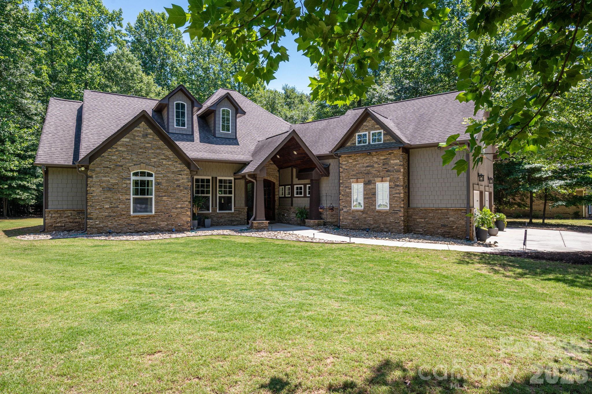 Escape to this stunning, custom-crafted 3-bedroom, 2.5-bathroom estate offering unparalleled privacy on a massive flat lot (almost an acre) just steps from the lake in the heart of Lake Wylie. The striking exterior blends hard-coat stucco, hardboard shakes, and natural stone for premium curb appeal, complemented by a sleek side-load 2-car garage. Inside, the home opens into an airy grand living space featuring soaring 14-foot ceilings, a stacked stone gas fireplace, and a freshly painted interior.

Designed for low maintenance and luxury, the floor plan features zero carpet—only timeless wood look plank tile throughout. Entertain with ease around the massive center island in the gourmet kitchen using the built-in wine fridge, gas cooktop and warming drawer.  The primary retreat overlooks the private backyard and has a the luxurious features you expect in a home of this caliber. Secondary beds both on main floor as well and have huge closets. Also, just off the foyer is a dedicated home office which could also be a 4th bedroom or head upstairs to the huge bonus room. There is also finished space (being used for storage) that can be finished as another full bath if needed (plumbing located just below it). The private backyard features a huge covered outdoor living space perfect for relaxing and enjoying the wildlife. At the back is also a 16x16 storage building and a firepit.  Mechanical excellence defines this home, boasting three separate HVAC units, a tankless gas water heater, and a massive amount of attic space with high potential for a third-floor conversion. Best of all, the oversized property features a full RV hookup wired for 50-amp service. Enjoy lake-side living with total freedom and absolute seclusion. And the best part, NO HOA!!!