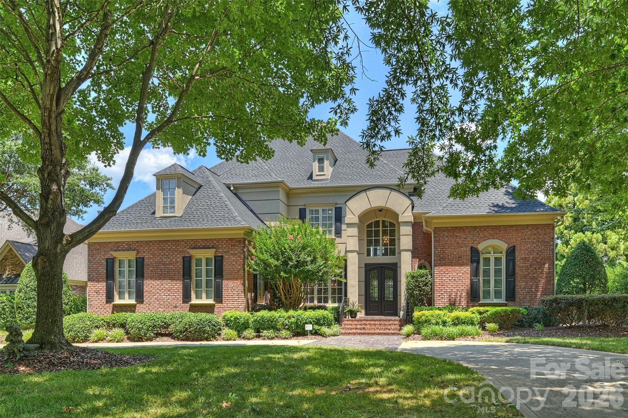 Welcome to 14747 Rudolph Dadey Drive, an extraordinary custom estate ideally positioned along the 16th hole of Ballantyne Country Club. Hand-selected by the original owner in collaboration with renowned Charlotte luxury home builder Stan Howey, this exceptional homesite was chosen for its rare, year-round elevated and unobstructed views of the 16th fairway, green, and lake. Opportunities to own a two-story custom home in Ballantyne Country Club with a setting of this caliber are exceptionally rare.

Designed for both elegant entertaining and everyday living, the home showcases timeless craftsmanship with an extensive multi-piece custom trim package, beautifully refinished hardwood floors (2022), and spacious living areas filled with natural light. The kitchen was updated in 2020 and is equipped with a Wolf gas range and oven, GE Monogram convection microwave and warming drawer, Fisher & Paykel dual dishwasher drawers, and overlooks a generous breakfast area and inviting family room anchored by a striking stacked stone fireplace.

The formal living room exudes sophistication with a coffered ceiling, fireplace, custom built-in cabinetry, and French doors that open to a covered terrace overlooking the pool, golf course, and tranquil lake view. The main-level primary suite is a private retreat featuring dramatic 17-ft (aprox) cathedral ceilings and a spacious updated bath completed in 2024.

Upstairs offers exceptional flexibility with dual staircases, and includes a sixth bedroom that can easily serve as a media or fitness room. A spacious recreation room with a dry bar opens onto a private balcony where breathtaking panoramic views of the golf course, lake, and Ballantyne Village skyline create the perfect backdrop for relaxing or entertaining.

Outdoor living is equally impressive with a beautifully updated pool featuring a completely replastered interior and new glass tile inlays (2025), covered terraces, a covered side-entry porch that leads to a full bathroom, and professionally maintained landscaping supported by a 12-zone irrigation system. A circular driveway and oversized three-car garage provide both convenience and impressive curb appeal.

Additional recent improvements include a brand-new roof (December 2025), custom Clark Hall steel front entry double door (2021), and gas water heater (2021).

Thoughtful functionality is found throughout with abundant storage, a spacious laundry room complete with cabinetry, utility sink, and a full bath for convenient pool access. Every detail reflects quality craftsmanship, making this an exceptional opportunity to own one of Ballantyne Country Club's most distinctive luxury residences.Community Amenities include: sidewalks, playgrounds, dog parks, sport court, 24-hour security & Social activities as part of the HOA and is open to all BCC residents.