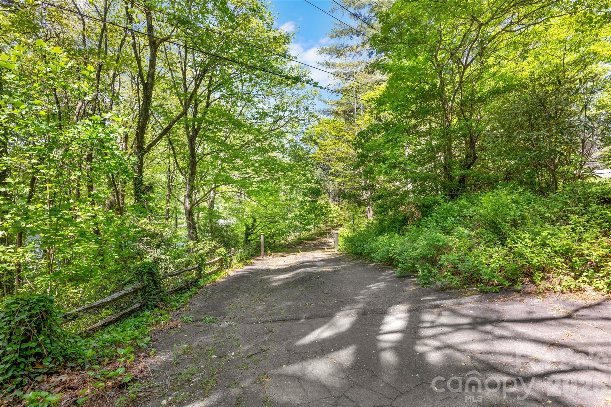 This exceptional Lake Toxaway property offers a rare opportunity to own a versatile and scenic homesite in one of Western North Carolina’s most sought-after communities. The offering includes a double lot totaling 1.278 acres, with the potential to divide, providing flexibility for future plans or investment. An additional parcel, Lot 50N, is also included, adding another 1.37 acres for expanded privacy or development options.
The property is already thoughtfully improved with a driveway in place, along with a boathouse and docks—making it easy to start enjoying lake life right away. Positioned to capture both lake and mountain views, the setting delivers a perfect blend of natural beauty and tranquility.
Conveniently located directly across the lake from the club, marina, golf course, and other premier Lake Toxaway amenities, this property combines privacy with easy access to recreation and social opportunities. Whether you’re envisioning a private estate or multiple homesites, this unique offering provides the space, location, and features to bring your vision to life.