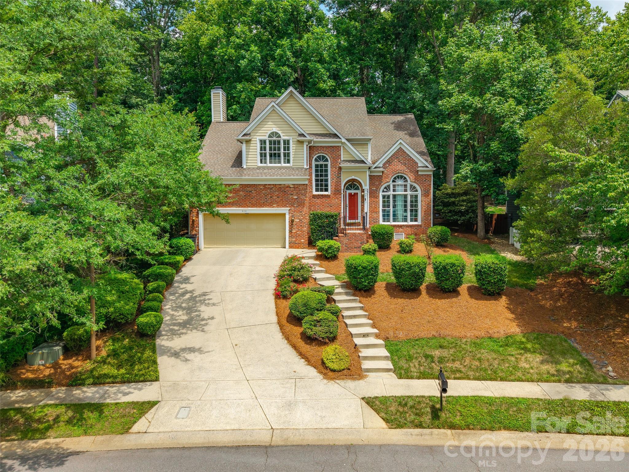 Welcome to 4131 Beauvista Drive in a sought-after golf course community! This 3-bedroom, 2.5-bath home offers timeless charm with thoughtful updates throughout. Inside you'll find vaulted ceilings, abundant natural light, a cozy wood-burning fireplace, and a dedicated office with sliding barn door and built-in cabinetry. The kitchen was updated in 2022 and offers a functional layout for everyday living and entertaining. The spacious primary suite features a clawfoot soaking tub, while the main-level and upper-level hall bathrooms were updated in 2022 and the two secondary bedrooms were also remodeled at that time. Upstairs includes new carpet in 2025, and one bedroom features a built-in desk that conveys. Outside, enjoy a fenced backyard with a lighted gazebo and treehouse. The garage offers epoxy flooring and loft storage, and the laundry room includes both gas and electric dryer hookups. Additional features include Ring doorbell, security system with indoor and outdoor cameras, and central vacuum system connected through the garage. Washer and dryer with built-in AI features may remain, and refrigerator may convey with an acceptable offer. Conveniently located near I-485, shopping, dining, and community amenities.