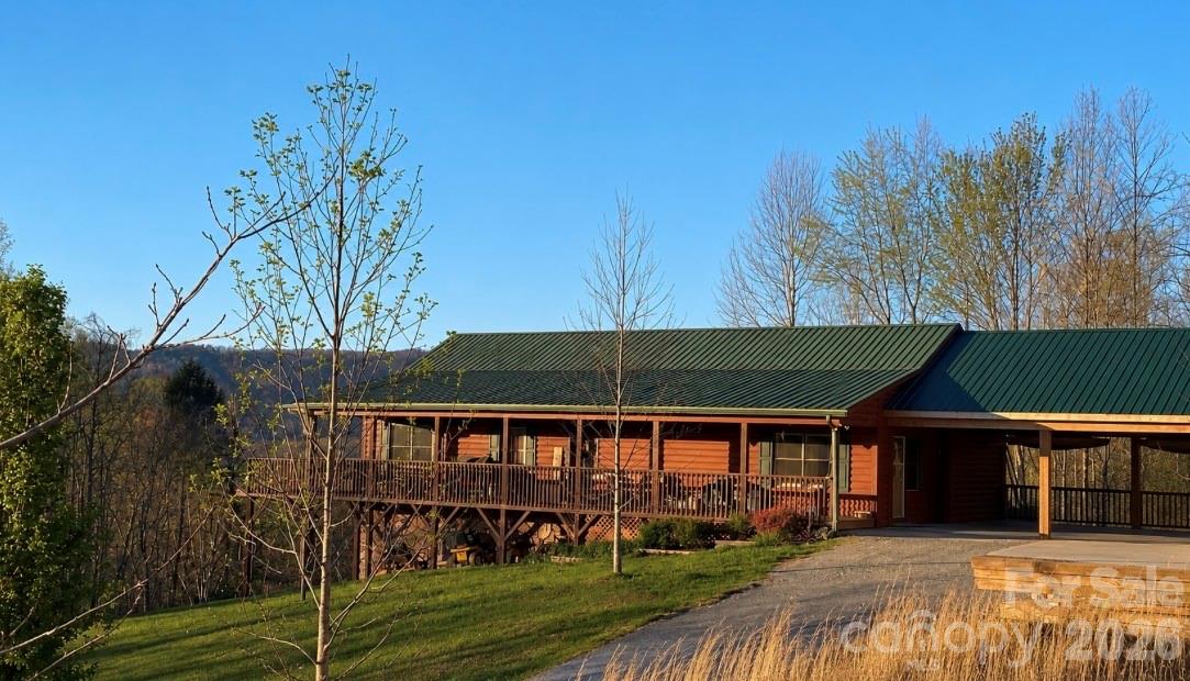 TRANQUIL HAPPY VALLEY HAVEN on Over 30 ACRES! You Found THE ONE! Welcome Home to this One Level, 3 Bedroom w/Bonus Room, 2 Bathroom Paradise That Has It All! Complete Privacy, Convenient to Town, & a Short 20 Min Drive to Blowing Rock & the High Country! Enjoy Sweeping Views of the Valley Below, Seasonal Views of Table Rock Mtn, & the Most Incredible Sunsets from your Wrap Around Deck! Abundant Wildlife Create a Hunter's Sanctuary! Small Stream, & Pasture w/Small Barn & Chicken Coop! In-ground Pool, w/custom side entry steps, fountains, and basketball goal was installed in 2022/2023, & sits beside a Pinterest Inspired Raised Bed Garden! Seeded Marigolds, Strawberries, and Asparagus will Decorate your garden every year! Apple, Plum, Peach and Blueberry Trees are Perfect For Picking! Gorgeous Perennials around the Property! Back At The House, You'll Enjoy The Benefit of an Oversized Double Carport, built in 2022/2023, 15 Year Siding Stain in 2021, New HVAC in 2023, New Hot Water Heater in 2026 and a Metal Roof that will Last! HVAC Has Just Been Inspected and Serviced and the Septic Tank has just been pumped. Inside Find a Large Living Room with Gorgeous Cathedral Ceilings and Tall Rock Gas Log Fireplace! This Fireplace was just installed in 2021, and a New Gas Burner in 2026. A Beautiful Kitchen with Hickory Cabinets, Brand New Granite Countertops, Sink and Matching Faucets! Large Custom Kitchen Island w/Quartz Counters, and Prep Sink! Kitchen is Open to a spacious Dining Room! With A Desirable Split Bedroom Layout, The Primary Bedroom Features a Spacious Room with a Beautiful Attached and Fully Remolded Full Bathroom Complete with a Large Walk In Shower, and Jacuzzi Tub! Also on this level, you'll find 2 Additional Bedrooms, Large Bonus Room and Additional Fully Remodeled Bathroom! Downstairs is a Full Unfinished Basement with Endless Possibilities! Don't Miss Out on This Rare Opportunity to Own a Special Piece of Happy Valley Haven! 
Surveyed in 2019. 
LISTING AGENT IS OWNER. 
Do Not Use GPS, Use Written Directions, Posted Signs and Tranquil Hills Drive to Access Home.