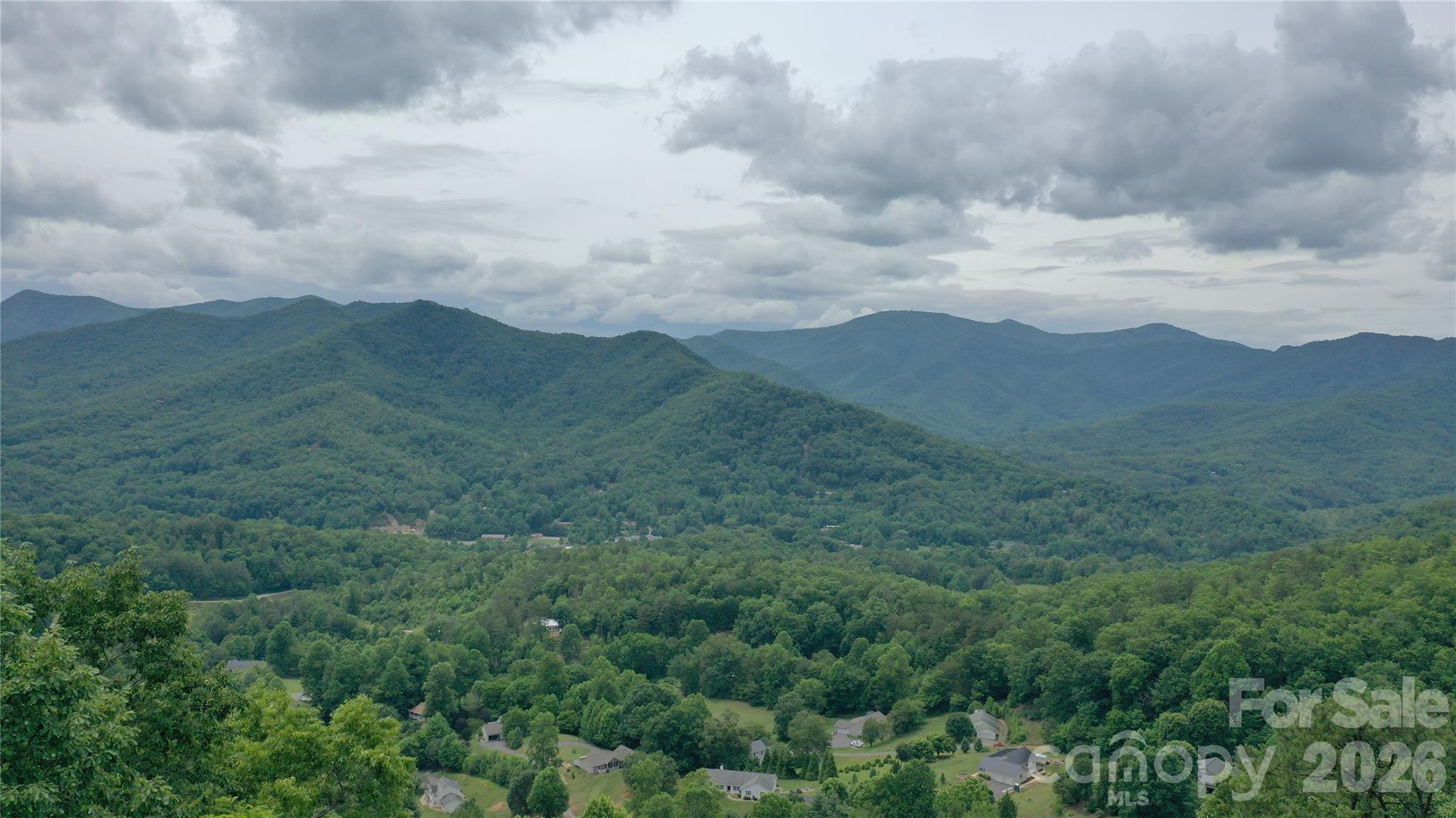 Build your mountain getaway with a view on this ridge line lot at 2850 feet in elevation, perfectly positioned to offer breathtaking views of the surrounding scenery. Situated in a prime location, this community provides the ideal balance of secluded mountain living while remaining incredibly close to the charming towns of Dillsboro, Sylva and Franklin, North Carolina. The property comes equipped with excellent infrastructure, featuring community water and underground power already available to protect your pristine vistas. This lot has an expired 3 bedroom septic permit and the groundwork previously laid offers a clear starting point for re-evaluation and development. Vacation rentals are allowed for a potential income producing property. Seller financing is available. Do not miss this exceptional opportunity to own a piece of Western North Carolina's natural beauty with convenient access to local shopping, dining, and outdoor recreation.