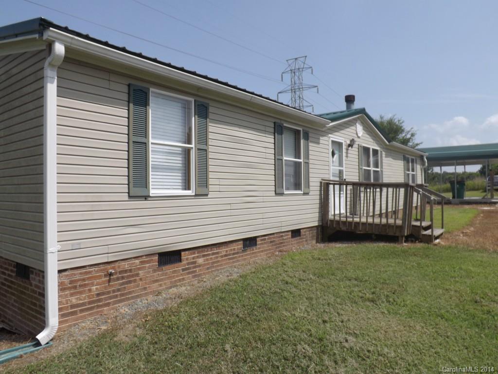 Updated home with nice lot located in the town Marshville.  Large living room plus a den. 3 bedrooms and 2 baths.  New roof in 2011, doubled floored in 2010, New carpet, vinyl & ceramic tile installed in 2011, new paint.  Concrete floor metal carport and storage building . tankless water heater.   Great condition!   FHA ready!! Engineer's report on file. Move in ready.
