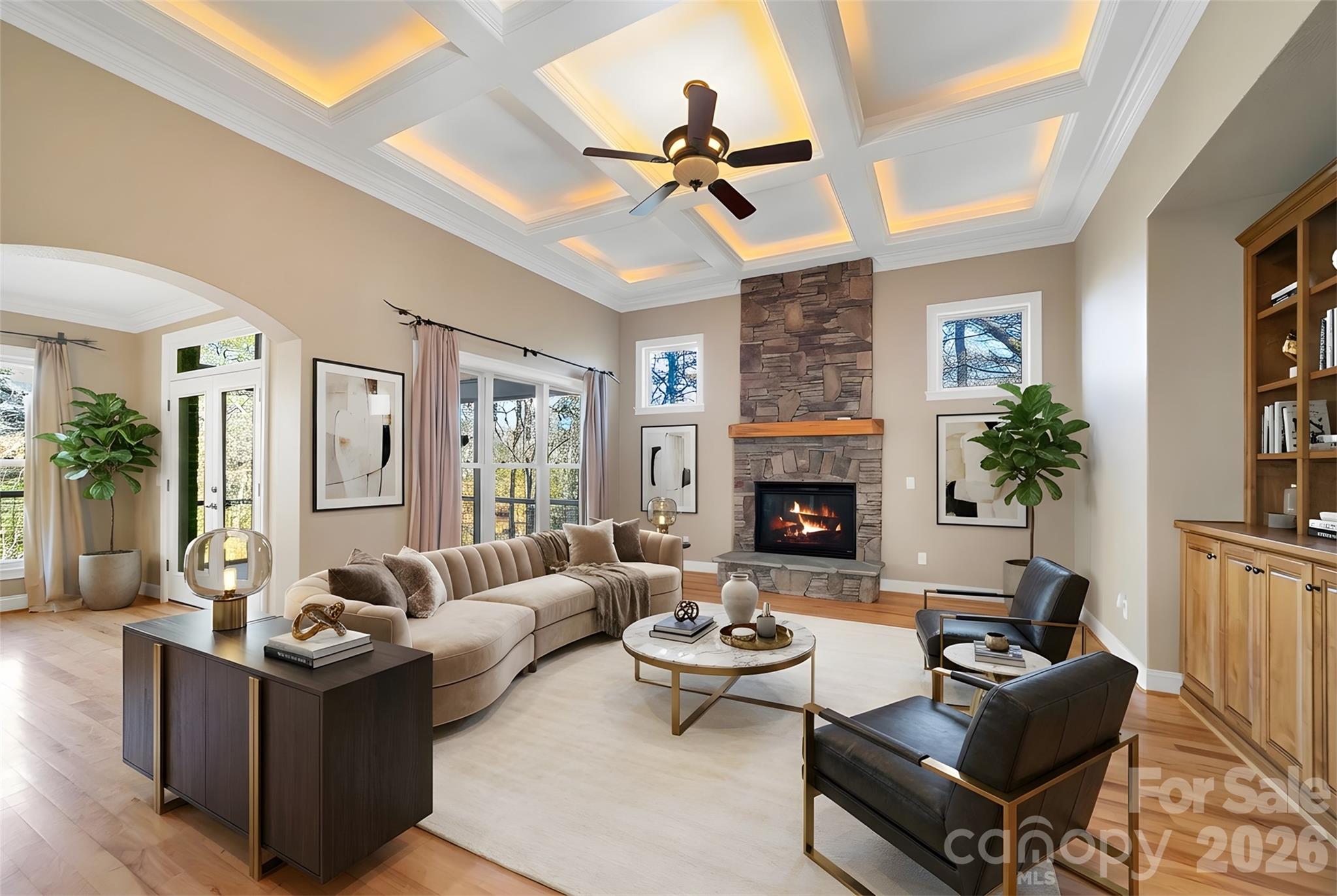 Rarely does a residence so flawlessly unite form and function, offering an atmosphere of refined luxury paired with exceptional comfort. From the moment you arrive, the striking custom metal front door and welcoming front porch hint at the elegance that awaits within. Step into the foyer and be greeted by a grand, light-filled living space wrapped in beautiful hickory floors. The open-concept kitchen—centered around a generous island—flows effortlessly between two distinguished living areas, each enhanced by its own stone fireplace. Expansive windows frame serene views of the level backyard, where direct access to Lake Atagahi allows you to kayak or fish from the privacy of your own property. The main-level primary suite provides a luxurious retreat with a spacious bath and walk-in closet. This level also features a formal dining room, a guest suite, a walk-in pantry, and a well-appointed laundry room—perfectly designed for everyday ease. Upstairs, two ensuite bedrooms offer comfort and privacy, complemented by a media room and a flexible bonus space ideal for an art studio, sewing room, or home office. The 2,419-sq-ft lower level is fully framed, heated, and primed for transformation—ready to become additional living quarters, a workshop, or an exceptional recreational haven. First time home buyers pay $14000 amenity fee at closing or $16000 at the end of the year