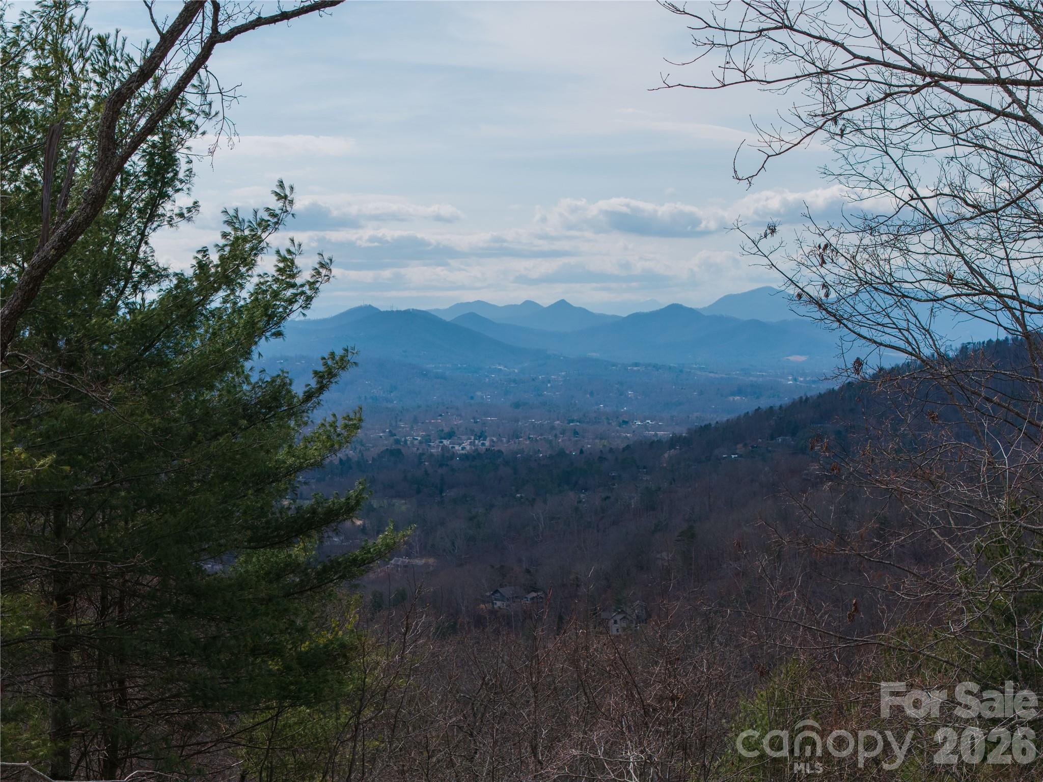 Looking for a unique homesite in North Asheville close to Elk Mountain Scenic Highway? Experience North Asheville living at its finest, with long-range mountain views that are some of the longest available anywhere in WNC! This beautiful 6 plus acre homesite sits on a gentle knoll and offers stunning views of the North side of town including Beaverdam Valley, Reynold’s Mountain and so much more. Bring your dream home plans to Fox Trails, a beautiful and private subdivision that feels like a retreat while keeping you close to everything. You’re only 7 miles from downtown Asheville and approximately 2 miles from the Blue Ridge Parkway.  Enjoy the ease of paved roads and the convenience of underground utilities—this lot is ready for your vision.