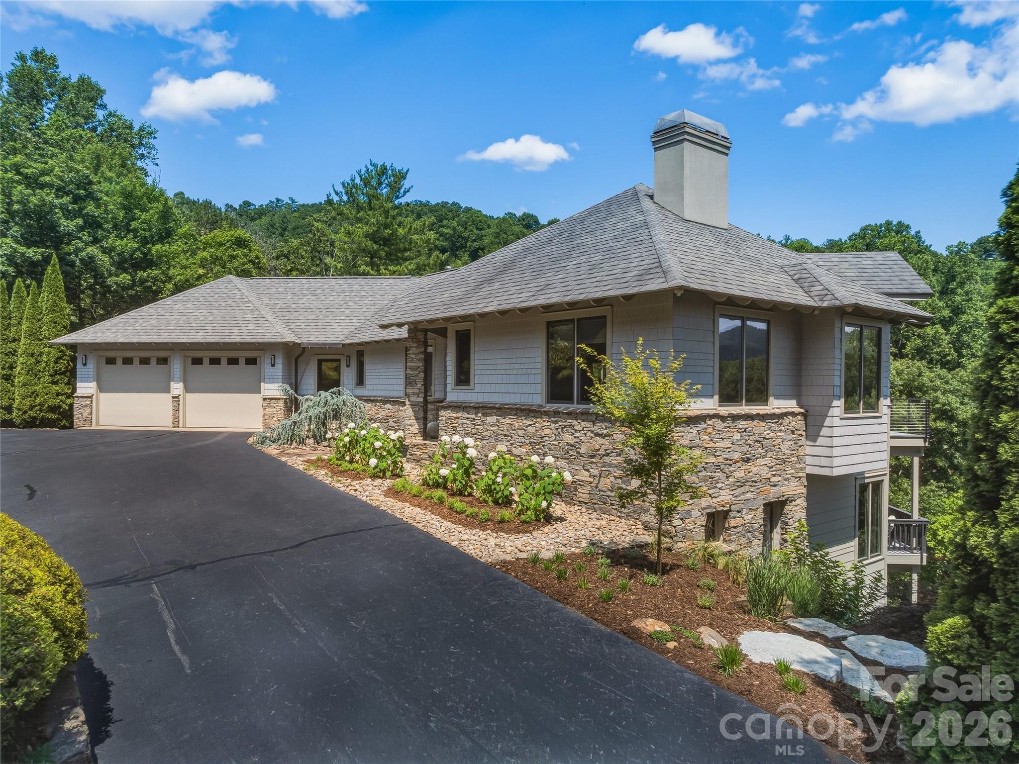 There is a particular kind of home that does not announce itself. It reveals itself slowly as you arrive at a residence that reads less like a listing and more like a considered act of architecture.
Set within the White Oak Ridge enclave of North Asheville, one of only ten homes on 30+ private acres, this 3,913-square-foot, four-bedroom retreat was conceived around the view and reconceptualized around the lifestyle. The exterior composition of cedar shake, fiber cement, and stone is the kind of material palette that ages into the landscape rather than against it. Inside, the transformed open floor plan moves with the light, connecting living spaces to a series of multi-level decks where year round views of the Blue Ridge unfolds across the horizon in every season.
The renovation is thorough and intentional: elevated selections, refined finishes, and a design sensibility that respects the home's scale without overwhelming it. Three and a half baths serve the private quarters with ease. For buyers who have learned that acreage and privacy rarely coexist with proximity to Asheville's arts, dining, and culture, 47 Garland resolves that tension on 2.39 acres in the city's sought-after North end.
For the buyer seeking a luxury home in Asheville with long-range mountain views and genuine privacy, this distinguished property earns its price on merit.