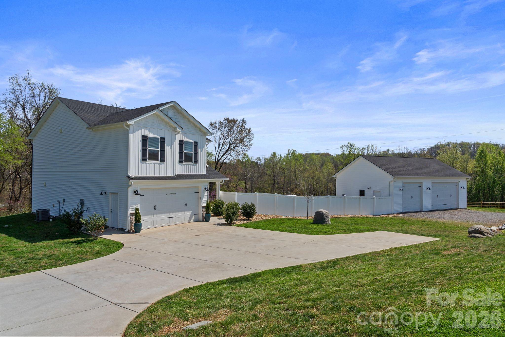 This well-appointed home sits on 2.06 acres, complete with a peaceful creek flowing along the back of the property. Enjoy luxury country living at its finest—while still being conveniently close to everything you need.

Car enthusiasts and hobbyists will appreciate the impressive approximately 1,200 sq ft (30’ x 40’) detached garage/workshop that is fully insulated and equipped with two Magnum 10,000 lb car lifts, a camera system, surround sound, and a gas pack for heating and cooling. With 10’ doors and 12’ ceilings, it’s built to handle it all.

The stunning heated and cooled in-ground pool and spa create a serene setting, perfect for entertaining or relaxing during quiet evenings at home. A cozy fire pit adds the perfect touch for cooler nights under the stars.

Inside, the home features an open floor plan with spacious rooms throughout, offering both comfort and functionality.

The home boasts a large kitchen with a massive walk-in pantry, an island with seating, stainless steel appliances, and a stylish subway tile backsplash. A convenient drop zone is located at the garage entry.

Upstairs, the primary suite offers a large walk-in closet, double vanity sinks, tiled shower walls and flooring, and a private water closet. Two additional bedrooms, a full hall bath with tile flooring, a linen closet, and a tiled laundry room complete the upper level. You’ll also find a spacious loft and a huge bonus room with double-door entry—perfect for a media room, office, or play space.

Upgrades throughout include spray foam insulation, quartz countertops, and comfort-height elongated toilets.

A dedicated tablet—conveying with the home—controls the pool functions and outdoor lighting for added convenience. Underground power lines enhance the property’s clean and scenic landscape.

Located in Troutman, nestled between Statesville and Mooresville, this area offers charming small-town living with exciting growth and expansion underway. Enjoy easy access to Lake Norman, as well as Charlotte, Greensboro, Hickory, and Winston-Salem.

This property truly has it all—a rare find and a must-see!