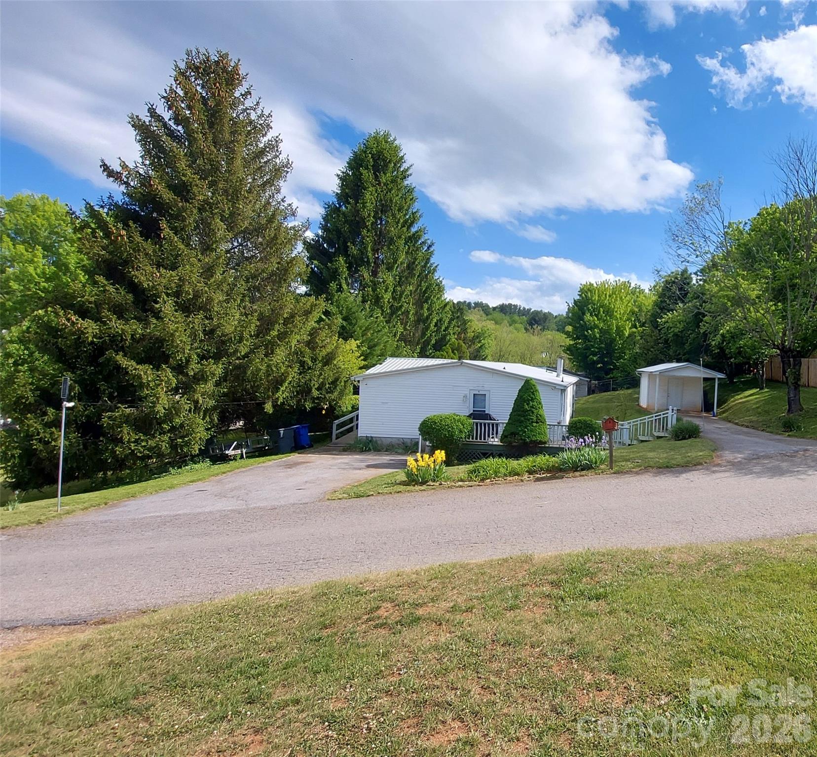 Very nice 3/2 split floor plan manufactured home on corner lot in Canton city limits. Easy access, 2 asphalt driveways. Publicly maintained roads. Short drive to Smokey Mtns. Nat’l Park, 30 minutes to Maggie Valley Ski Resort, minutes to I-40. Centrally located to Waynesville, Clyde, Candler, and Asheville. In 2020 installed new low e windows, storm doors, Lifeproof core vinyl plank flooring, new paint throughout, new heat pump, and new 3 ton mobile home coil. In 2021 installed new roof and built shed. Refurbished ramp and screened in front porch in 2023. Small workshop (w/electricity) and carport. School bus pick up by front yard. Pet free, smoke free, outside solar lighting, city water/sewer. Peach tree/apple trees. No damage from Fred or Helene.  Flood Zone is Zone X.