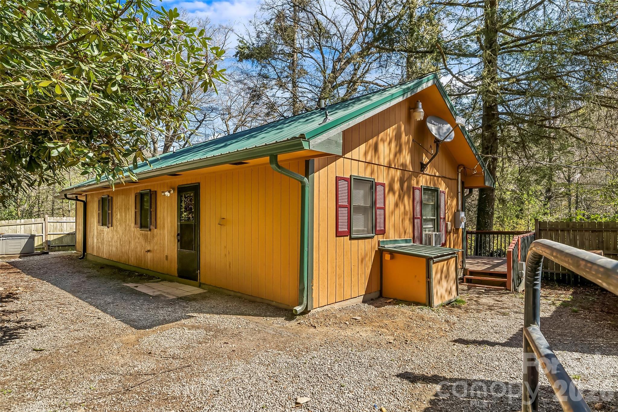 NEWLY UPDATED! Your mountain escape—and income opportunity—awaits in beautiful Maggie Valley. With a proven track record as both a short- and long-term rental, this charming retreat is equally suited for investment or your own private getaway.

Tucked away on over half an acre with fencing and a peaceful, woodsy backdrop, this home invites you to slow down and settle in. Inside, you’ll find 2 bedrooms plus a spacious bonus room, giving you plenty of flexibility for guests, work, or play. Vaulted ceilings elevate the kitchen, where stainless steel appliances and ample dining space make gathering easy. The open living area centers around a stunning stone gas-log fireplace, bringing cozy, lodge-style vibes year-round. Fresh luxury plank flooring flows throughout, adding a clean, updated feel.

Step outside and take it all in—whether you’re sipping coffee on the covered porch, unwinding on the deck, or soaking in the quiet mountain setting. A new well adds peace of mind, while the surrounding nature delivers that true “getaway” feeling.

And when adventure calls, you’re in the perfect spot—just minutes to skiing, hiking, the Blue Ridge Parkway, and all the fun of Maggie Valley. Whether you're looking to relax, explore, or earn, this one checks all the boxes.