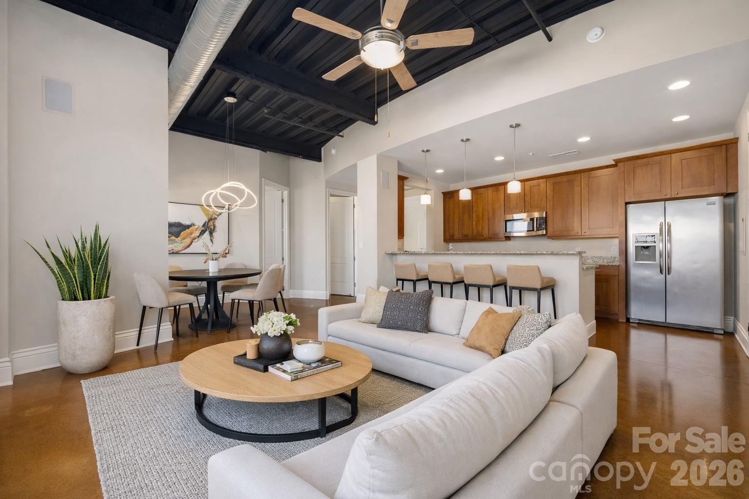 !! MOTIVATED SELLER !! BRING ALL OFFERS !!! Seller will consider covering the remainder of 2026 HOA dues OR offer other buyer incentives with an acceptable offer! Ask about a possible rate buy-down to make this home even more affordable!! 

Located just steps from NoDa’s popular bars, restaurants, breweries, and art galleries, with quick access to Villa Heights, Plaza Midwood, South End, and Uptown via the light rail!  This industrial-modern condo in the heart of NoDa blends style, space, and unbeatable walkability. Featuring 10-ft ceilings, exposed concrete floors, and an open, sun-filled layout, the home feels airy and effortlessly cool—perfect for both entertaining and everyday living.

The open kitchen shines with granite countertops, stainless steel appliances, generous storage, and bar seating ideal for hosting. Two bedrooms and two full baths offer flexibility for work-from-home, guests, or roommates.

Step outside to two private balconies and take in Uptown Charlotte views—perfect for morning coffee or evening cocktails. Residents also enjoy a 5th-floor rooftop terrace with stunning skyline views and nearby pet-friendly green spaces.

HOA includes water and sewer. All appliances convey. HVAC replaced in 2024.
Stylish, walkable, and move-in ready—this is city living done right.

** Please note the pictures are virtually staged **