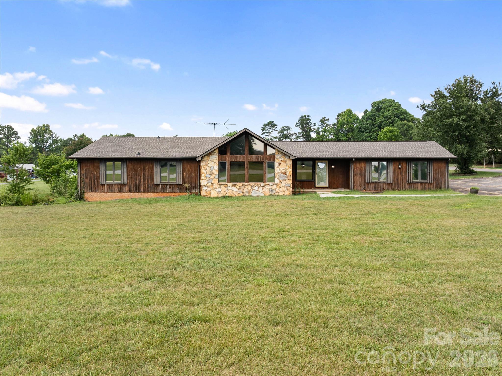 Don’t miss the chance to enjoy the rest of the summer in the pool or hot tub! This charming single-level home features 2 bedrooms with ensuites, a den/living room/bonus area, a great room with a cathedral beamed ceiling, and a gorgeous kitchen with a walk-in pantry. The basement offers a fabulous living area, an extra flex space, and an additional garage perfect for a workshop or tool storage. Cook up a feast in the outdoor covered grill area and take advantage of the spacious outdoor living space for entertaining or relaxing. With 2.10 acres, there’s plenty of room to spread out. Just minutes from Lake Norman and I-40, this beautiful home is ready for you!