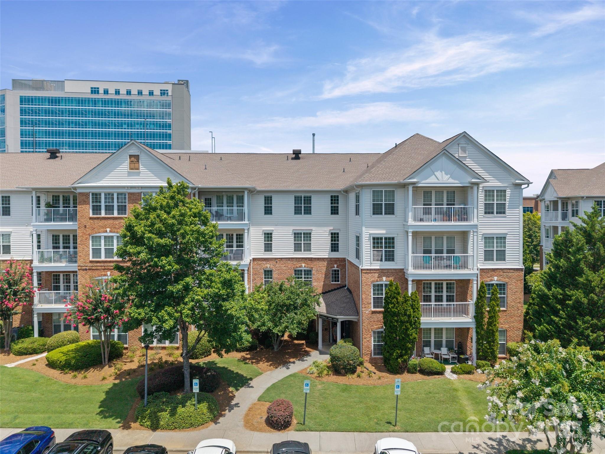 Enjoy luxury living and unbeatable walkability in the heart of Ballantyne all wrapped into one stunning top-floor condo in the gated, resort-style community of Belle Vista! Just steps from Ballantyne Village and a short stroll to The Bowl & Ballantyne Backyard Park. Enjoy an open layout featuring hardwood floors, fireplace, and a covered balcony perfect for sipping coffee or relaxing under the trees. Ideal for everyday cooking or hosting in style, this kitchen is complete with granite and stainless appliances. The primary suite is a true retreat featuring custom closet shelving and a premium organization system. Newer carpeting in bedrooms adds comfort and style throughout. Good-sized laundry/utility room provides shelving for extra storage too. Elevate your everyday living with resort-style amenities— a sparkling pool, clubhouse, and recreation area. Washer, dryer & refrigerator remain. Move-in ready with a fabulous upscale location—stop looking and start unpacking today!
