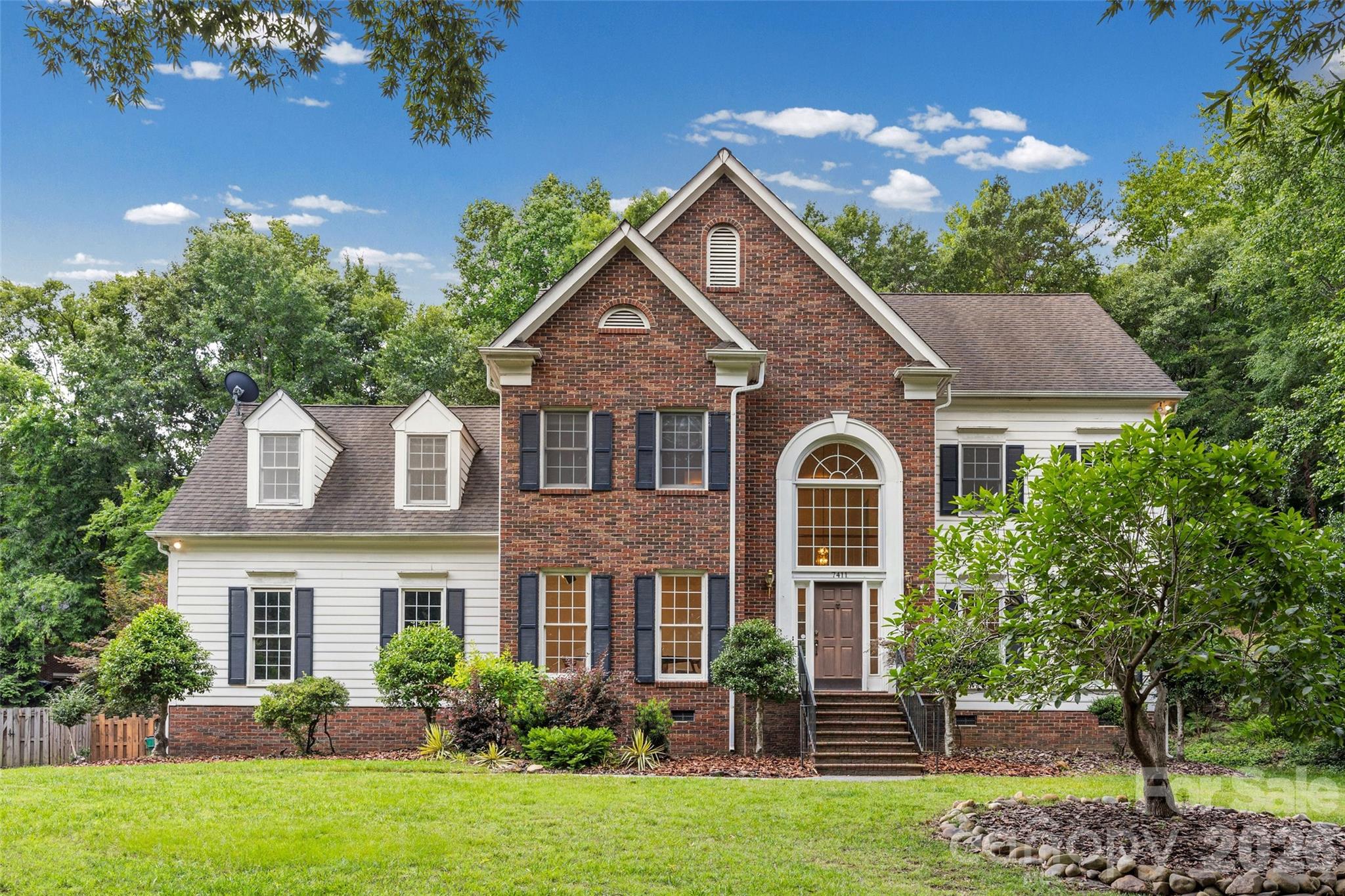 Welcome to this stately brick-front home nestled on a private wooded lot with a long driveway and timeless curb appeal. Featuring 3 bedrooms plus a spacious bonus room that could be a 4th bedroom, this home offers an open floor plan with soaring ceilings and a large living room anchored by a fireplace, creating the perfect gathering space for family and friends.

The living area flows seamlessly to an expansive deck overlooking a spa-like backyard retreat complete with a beautiful pool, providing the ideal setting for entertaining or relaxing in your own private oasis. The spacious primary suite offers a comfortable escape, while the attached garage and functional layout provide everyday convenience.

Many of the major-ticket items are already in place, giving buyers the opportunity to add their personal touches and make this home truly their own. With generous living spaces, a sought-after wooded setting, and exceptional outdoor amenities, this property offers the perfect combination of comfort, potential, and lifestyle.

Don't miss the opportunity to create your dream home in this desirable setting.