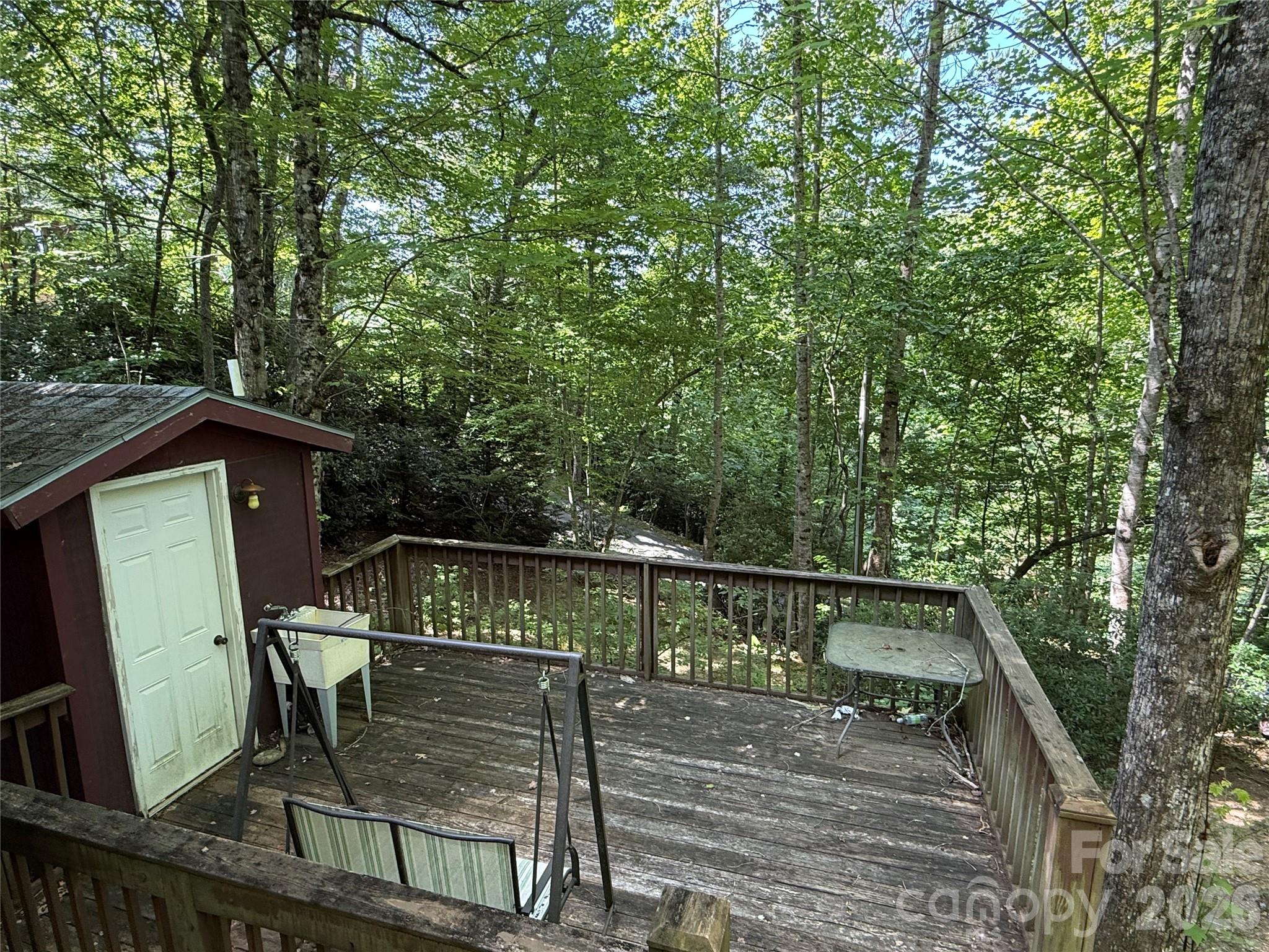 Great location with utilities in place! Minutes from Sylva, Cherokee, Dillsboro, and Bryson City. Nice porch with a bathhouse and the solid framework of a huge yurt. Two-bedroom septic system, community water, and electricity on property. Paved roadway to the site!