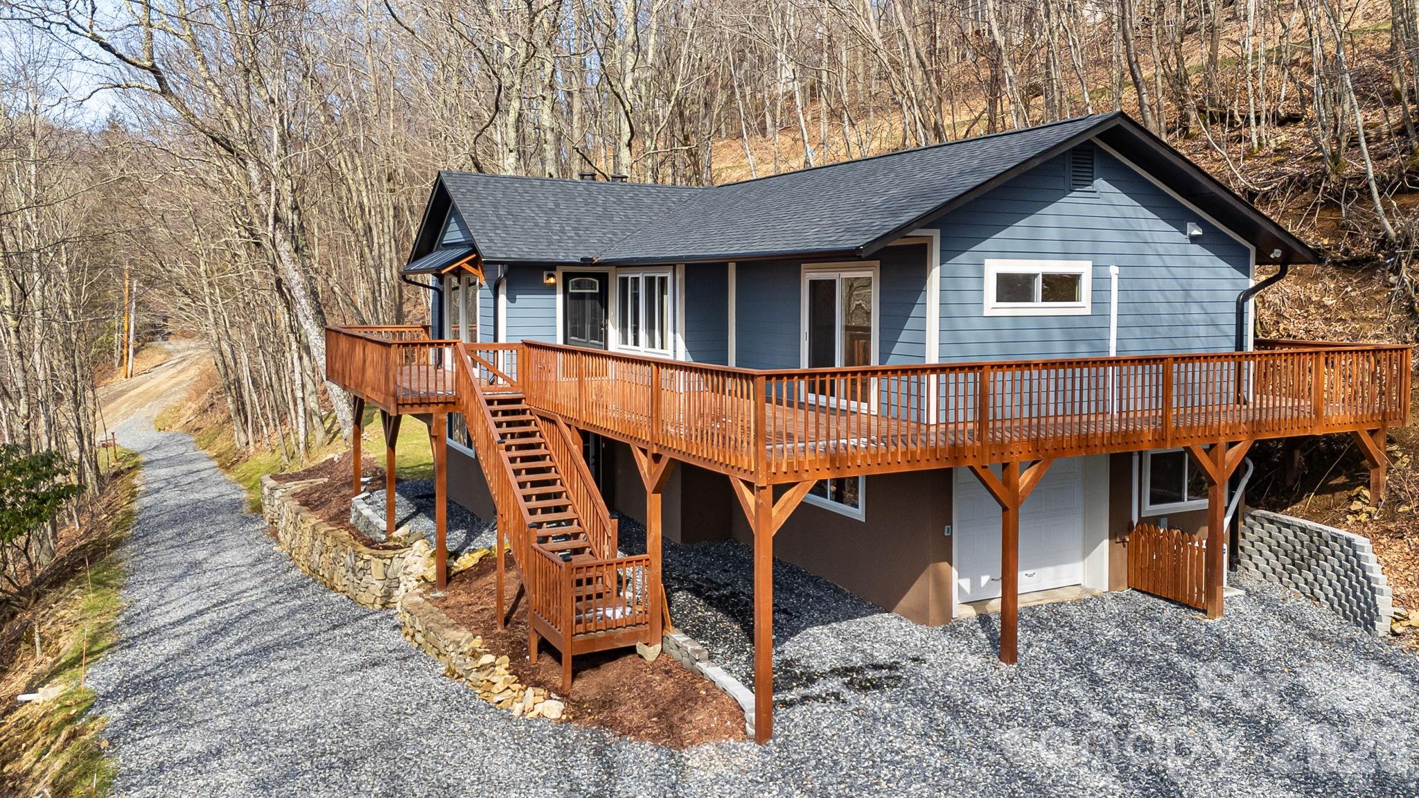 Breath-Taking Renovated Mountain Home close to country club and pro shop. Sit on your deck and take in the beautiful sunsets. Main level offers primary suite w/private bathroom, sliders with access to deck, flex space for a desk and W/D. 2nd bedroom with full updated bath right outside the door. Great room with large windows to bring in lots of light and airy feel. Stone fireplace w/gas logs and can lighting. Open floor plan with breakfast bar, pantry, quartz countertops and stainless appliances. Lower level with family room with stone fireplace and gas logs, full kitchen w/stainless appliances and quartz counters. Two bedrooms with ceiling fans and updated shared bathroom. Ductless mini splits offer zoned heating and cooling. New roof, gutters, windows, sliding doors, lighting, drywall throughout, siding, doors, kitchens, baths, W/D on each level, new deck and landscaped. Lower level perfect for STR or extended families with its own entrance. This home is ready to move into and enjoy the beautiful 4 seasons the community offers. Hatley Pointe Ski Slopes and Resort inside gated community. Wolf Laurel Country Club and 18-hole picture perfect golf course, Village club with tennis, pickle ball, outdoor pool, community center and events, access to the Appalachian Trail and many hiking trails. (Wolf Laurel CC and Golf/ Village Amenities require memberships to participate) High elevation makes the summers very mild and comfortable. Security gate manned 24/7, many more extras, too many to list. Close access to I26 corridor, fly fishing, whitewater rafting, more hiking, local festivals, Ebbs Chapel Event Center featuring blue grass concerts and many other events. 35-minute drive to Asheville, 50-minute drive to Johnson City Tennessee. Come view this very special mountain retreat for full time or part time living.