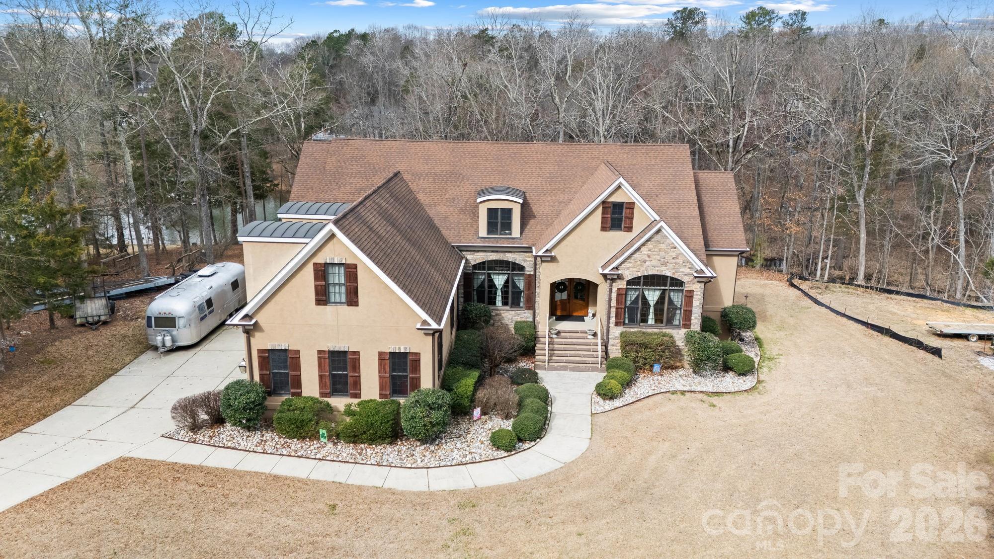 Opportunity knocks on Lake Wylie with this move-in ready home offering incredible expansion potential.

The main level features a spacious and well-designed layout with a beautiful primary suite showcasing multiple tray ceilings, heavy crown molding, a spa-like bath with jetted tub, tiled walk-in shower, and separate walk-in closets. An office with vaulted ceiling, large dining room, and a welcoming great room with gas log fireplace create comfortable spaces for both everyday living and entertaining.

The kitchen truly serves as the heart of the home, complete with double ovens, cooktop with hood and pot filler, bar seating, breakfast nook, keeping room, and custom cabinetry throughout. Two additional bedrooms and a convenient laundry room are also located on the main level.

Upstairs, a large bonus room over the three-car garage offers flexible space along with its own full bath—perfect for guests, hobbies, or a private retreat.

Downstairs, the unfinished walk-out basement is already well on its way to becoming a full second living area. With plumbing, electrical, and framing already in place, there is room for additional bedrooms, multiple bathrooms, a second kitchen, great room, rec room, wine cellar, fitness space, and more—essentially allowing the home to double its living space.

Outside, enjoy life on Lake Wylie with your private covered dock and boat lift, all with no HOA, surrounded by attractive homes in a desirable community.

Located in the award-winning Clover School District, with low South Carolina taxes, this area of Lake Wylie continues to grow in popularity. Finish the basement over time and create lasting value while enjoying lake life for years to come.