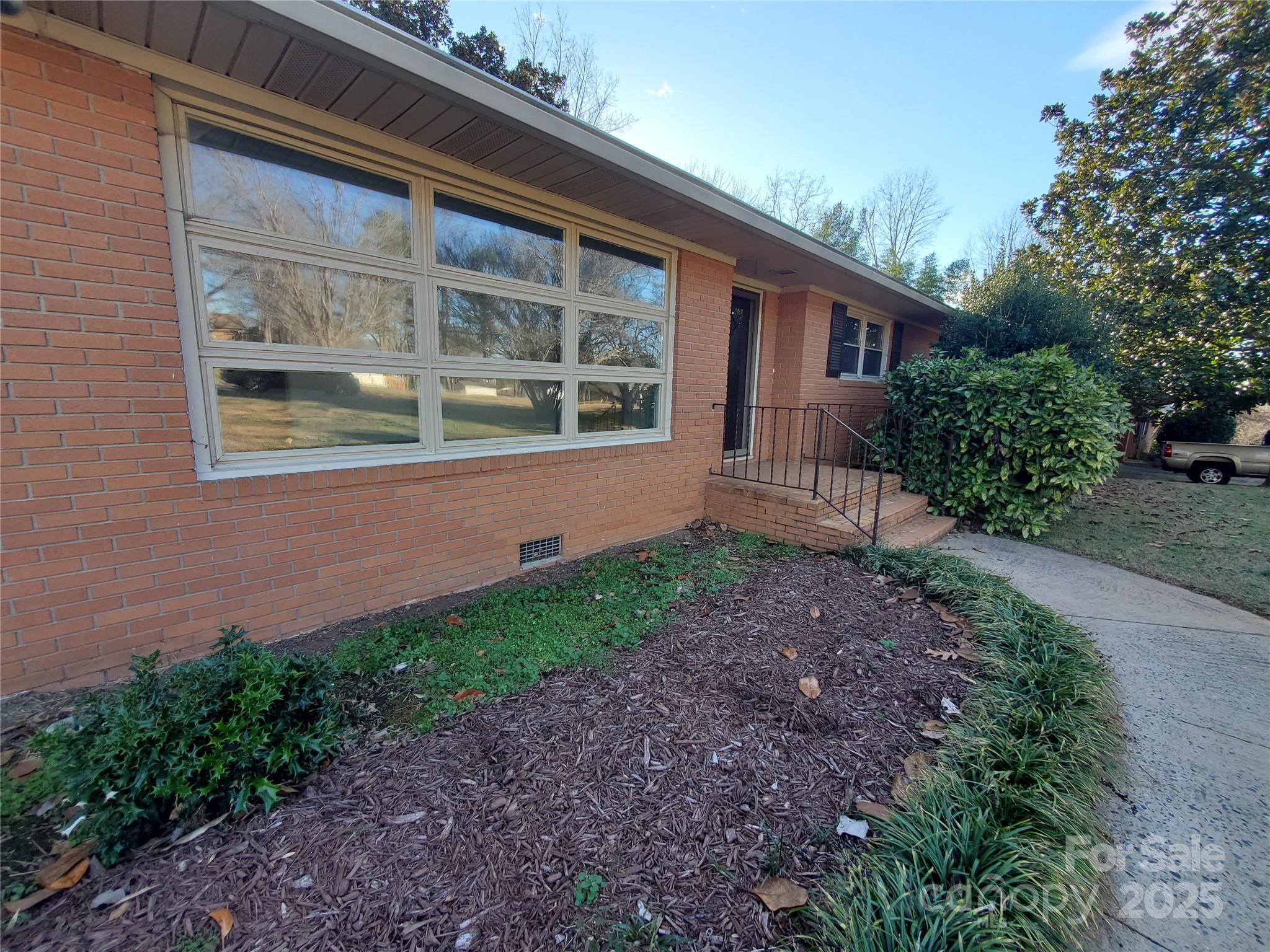 Welcome to your new Mid-Century brick ranch. Discover this charming Mid-Century brick ranch, nestled in a serene Shelby neighborhood and conveniently situated near Highway 74. Enjoy a spacious lot with a large rear deck, offering excellent opportunities for customization to meet your needs. This home features three bedrooms and two full bathrooms. The layout provides versatile gathering areas with options for privacy, highlighted by a spacious living room and an expansive Kitchen-Den-Breakfast area. One of the full baths includes a walk-in tub, which may appeal to specific buyers. A notable feature of this property is the whole home generator, a rarity in many residences. The furnace was replaced in 2021, and new flooring added in 2024. The seller acknowledges the need for some updates, so let’s begin that discussion. Great news for USDA loan seekers: this home qualifies for USDA loan options!