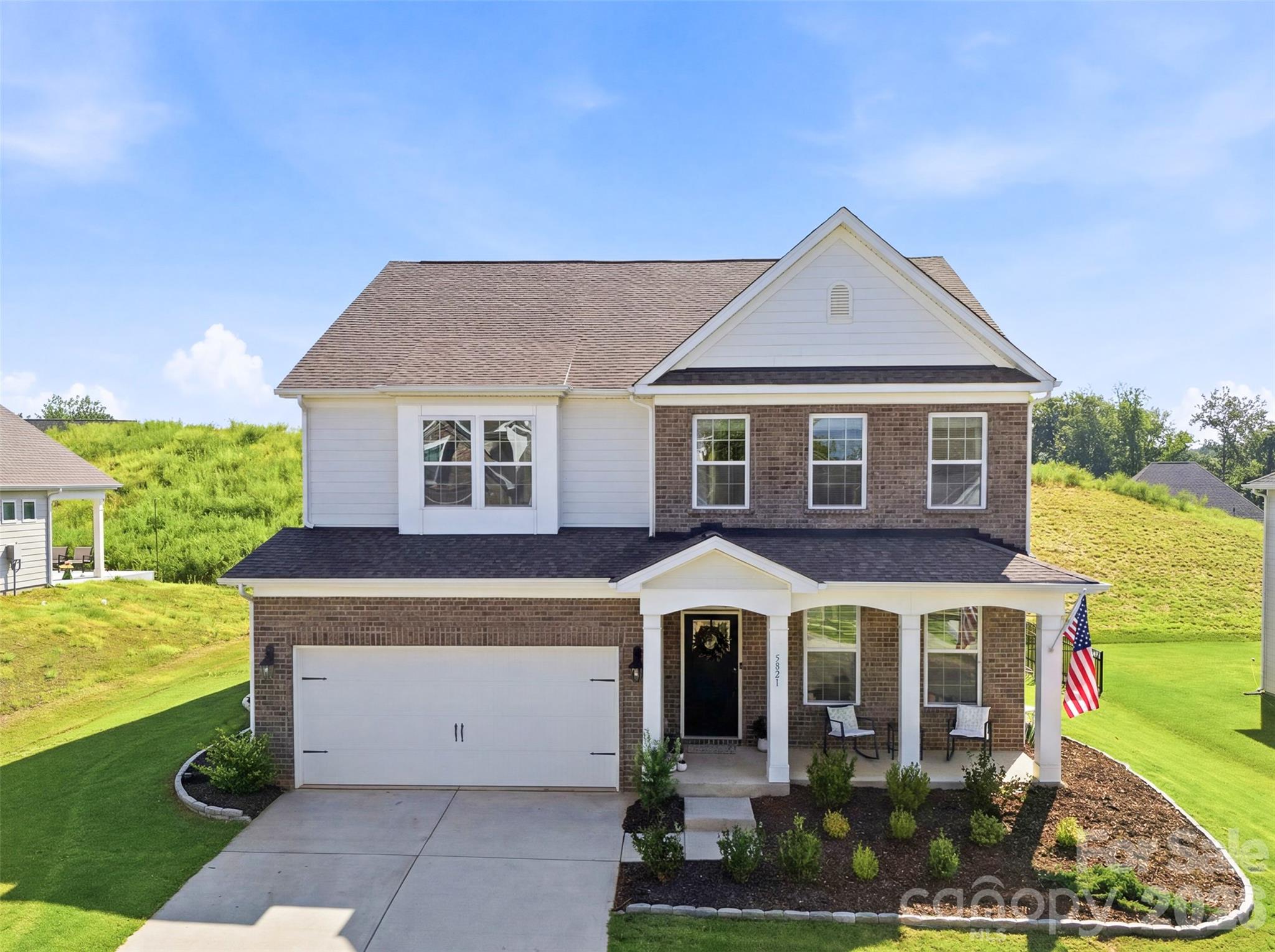 Welcome home to 5821 Casper Drive, where every detail is straight out of a Pinterest board. Built just two years ago in the highly desirable Vineyards on Lake Wylie community, this home offers the peace of mind of newer construction with the added benefit of $25,000+ in thoughtful upgrades the builders don't include. Since purchasing, the sellers have invested extensively in enhancing the home with elegant picture molding, updated designer lighting, and custom window treatments throughout, creating an elevated feel in every room. A stunning laundry room featuring custom cabinetry, quartz countertops, a tile backsplash, and a utility sink create a space that's as beautiful as it is functional. Outside, the upgrades continue with a professional irrigation system, extensive landscaping, and an extended patio perfect for relaxing or entertaining. Life in The Vineyards on Lake Wylie is about more than just the home. Residents enjoy resort style amenities, including two pools, a clubhouse, fitness center, tennis and pickleball courts, soccer field, playground, walking trails, lake access with a kayak and paddleboard launch, and a packed social calendar that makes it easy to connect with neighbors. Conveniently located just minutes from Charlotte Douglas International Airport, Uptown Charlotte, shopping, dining, and everyday conveniences, you'll enjoy the feel of a private retreat without sacrificing proximity to the city's best amenities. Why wait to build when you can own a better than new home with all of the upgrades already completed? Move right in and start enjoying the lifestyle you've been waiting for!