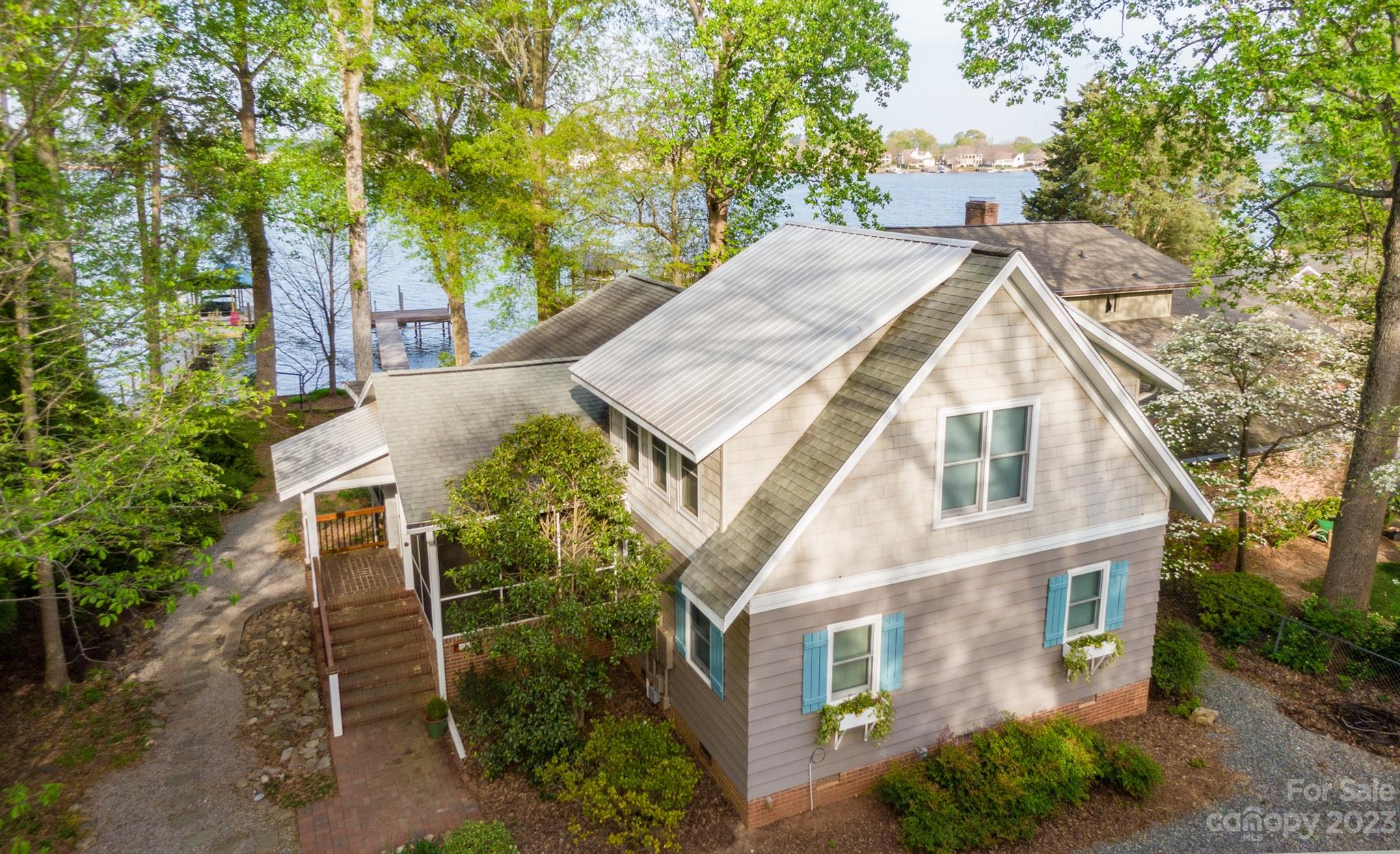 Absolutely breathtaking waterfront home with long range open water views on a beautifully manicured lot in the highly desirable Westport community! Walk to the end of the pier to enjoy a morning cup of coffee as the sun rises over Governors Island across the sparkling waters of Lake Norman. This home does not have a shortage of outdoor living space! Offering a large deck across the back of the home facing the lake and a spacious screened in tiled porch off of the kitchen, you won't know which outdoor area to enjoy first. Continue to be dazzled by the natural light that pours into this home, lighting up the soaring 2 story family room with exposed beams, imported heart pine wood floors and custom stone fireplace. The bedrooms, office and flex room all have beautiful lake and garden views from every window. Enjoy lake life in a great Denver location! Close to Westport swim/tennis & golf club, grocery stores & restaurants! *Majority of windows replaced (Anderson/Pella) newer water heater