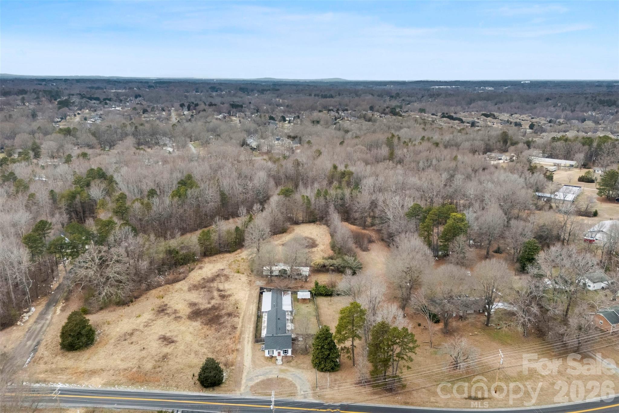 FANTASTIC one-of-a-kind property and opportunity on .98 acres located in the heart of Gastonia. This property offers a +/- 730 square foot dwelling/ office/ home with a living/ greeting area, kitchen, den area, separate "room", and bathroom. Connected to the dwelling are two indoor/outdoor areas/ storages formally used as a kennel. There is a mobile home at the back of the property! Theres approximately 150 feet of road frontage. GREAT property for a business and location couldn't be better. The current zoning is R-1 and will require a rezoning or conditional zoning to convert to commercial.
